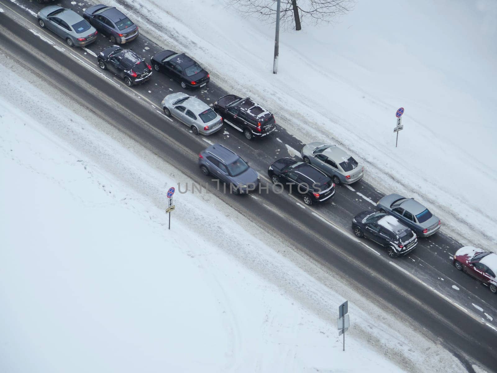 Winter road in the white snow on the diagonal from above
