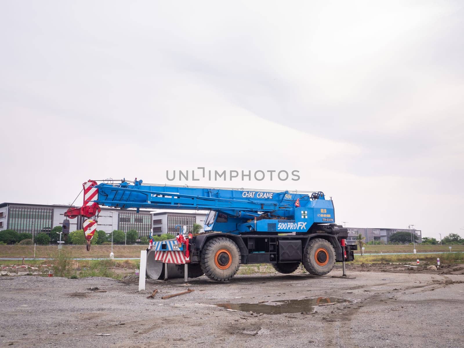 Construction site crane is lifting a led signboard Blank billboard on blue sky background for new advertisement