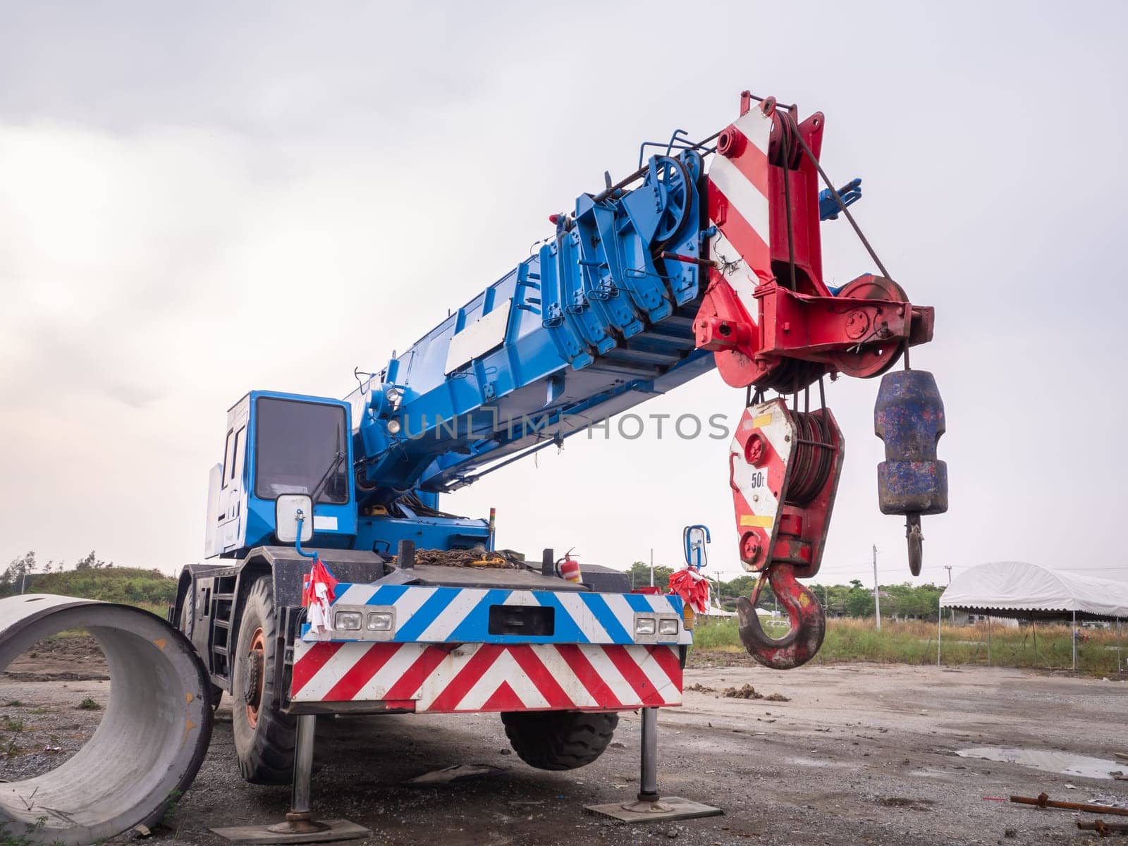 Construction site crane is lifting a led signboard Blank billboard on blue sky background for new advertisement