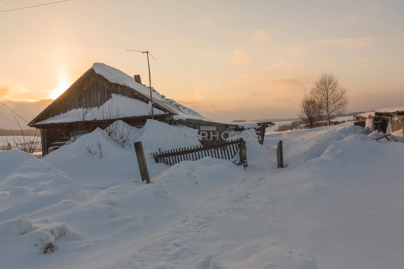 Old wooden house on a snowy winter day.