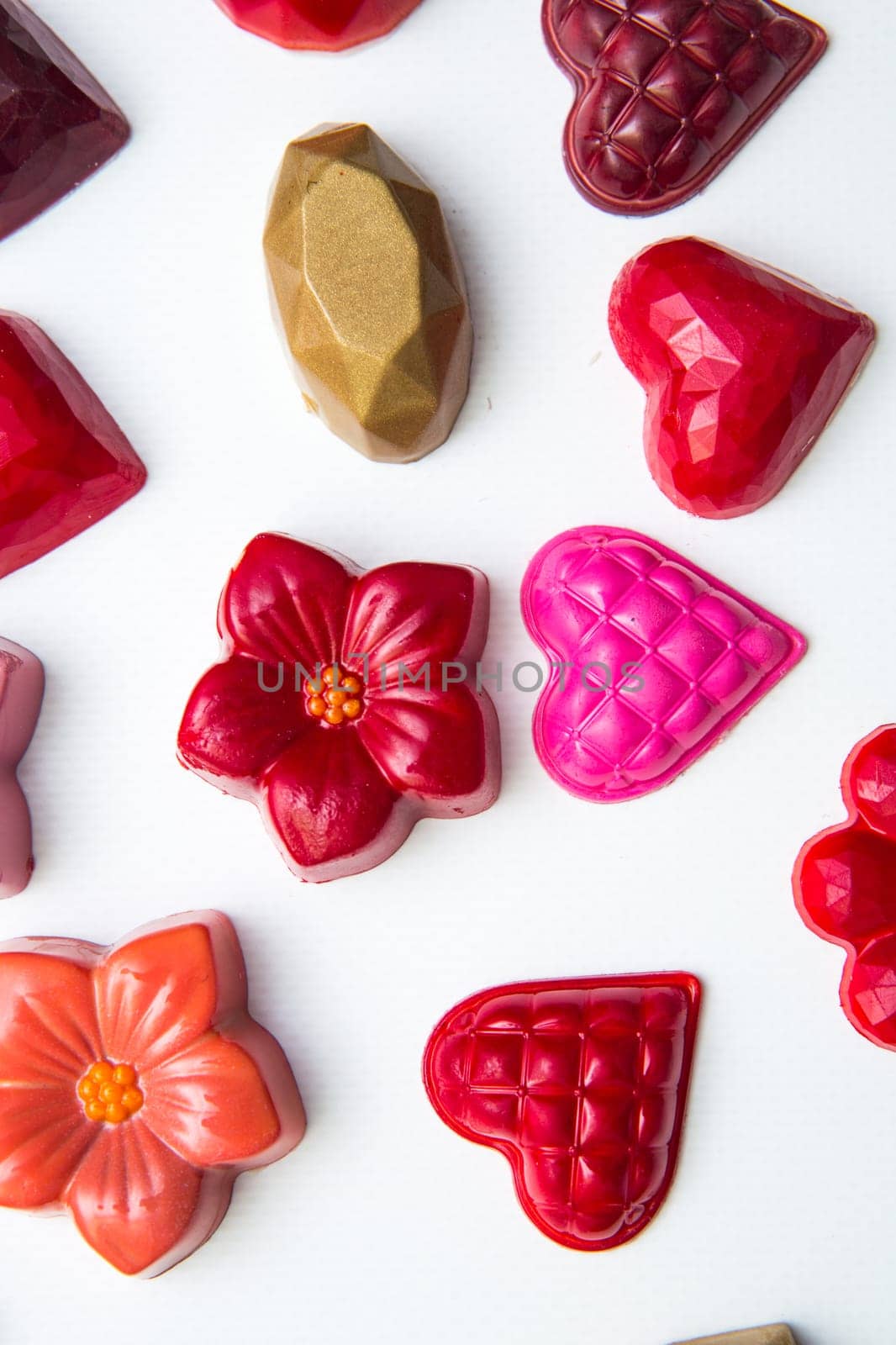 Delicious chocolate candies, close up, different colors.