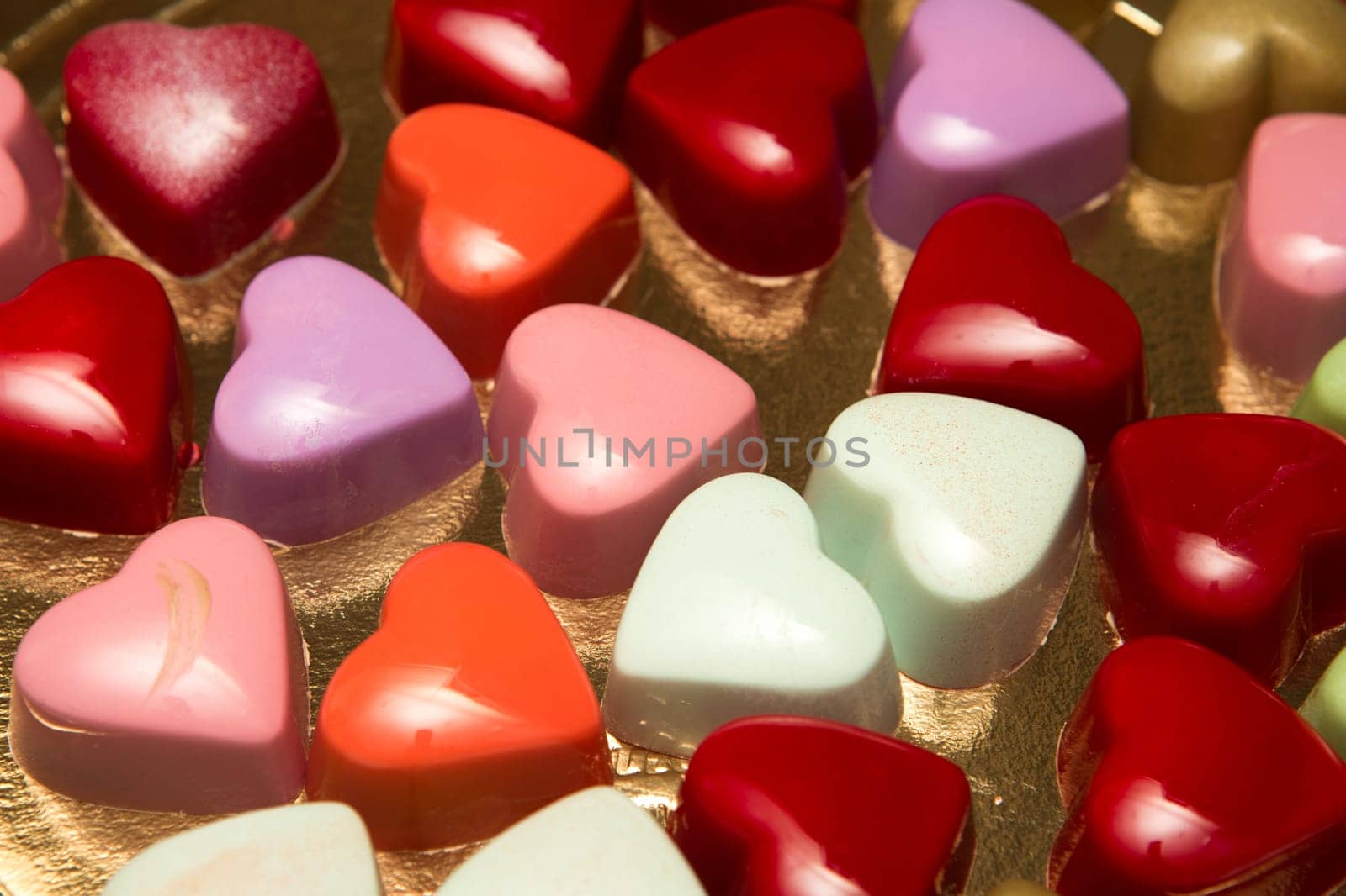 Delicious chocolate candies, close up, different colors.