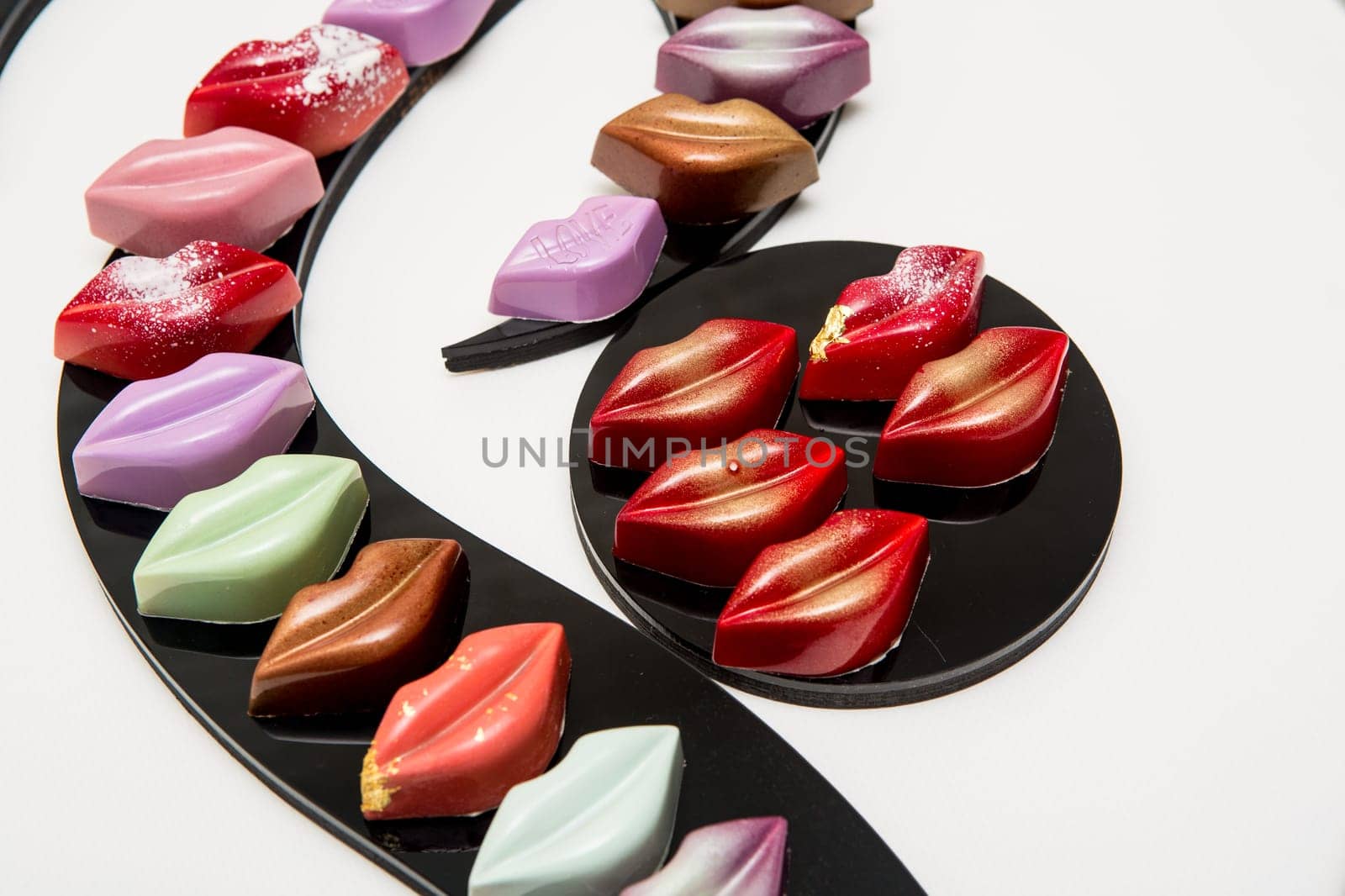Delicious chocolate candies, close up, different colors.