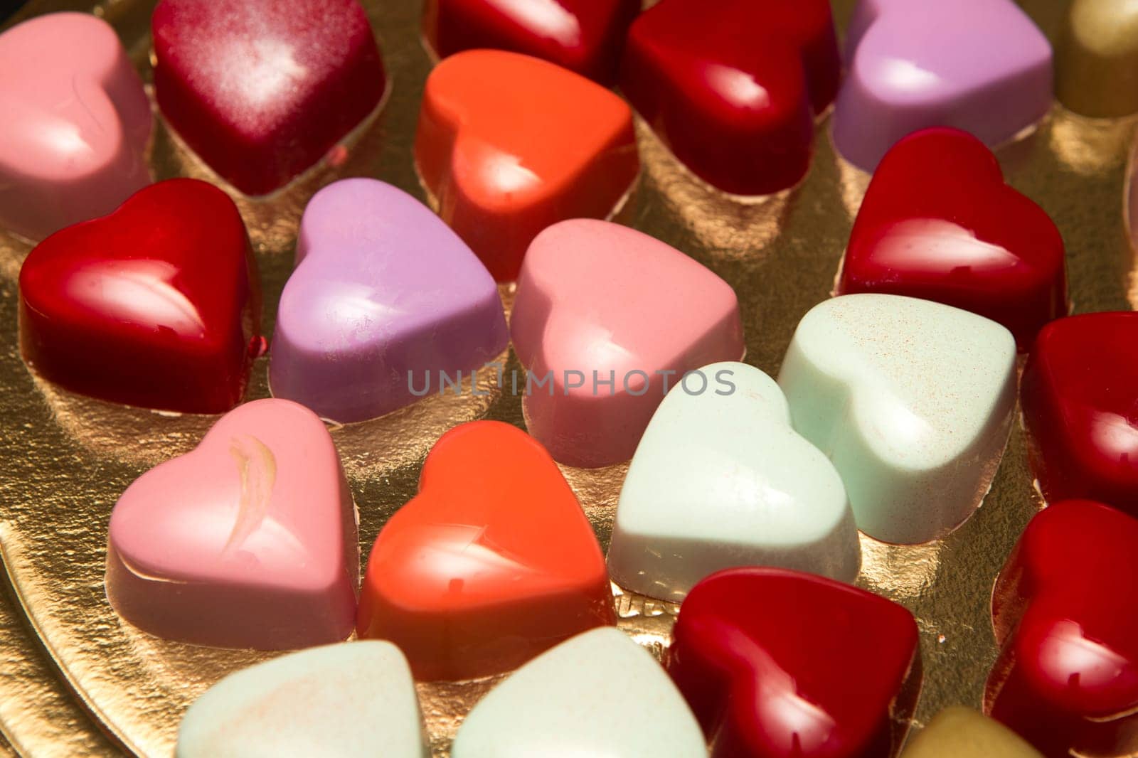 Delicious chocolate candies, close up, different colors.