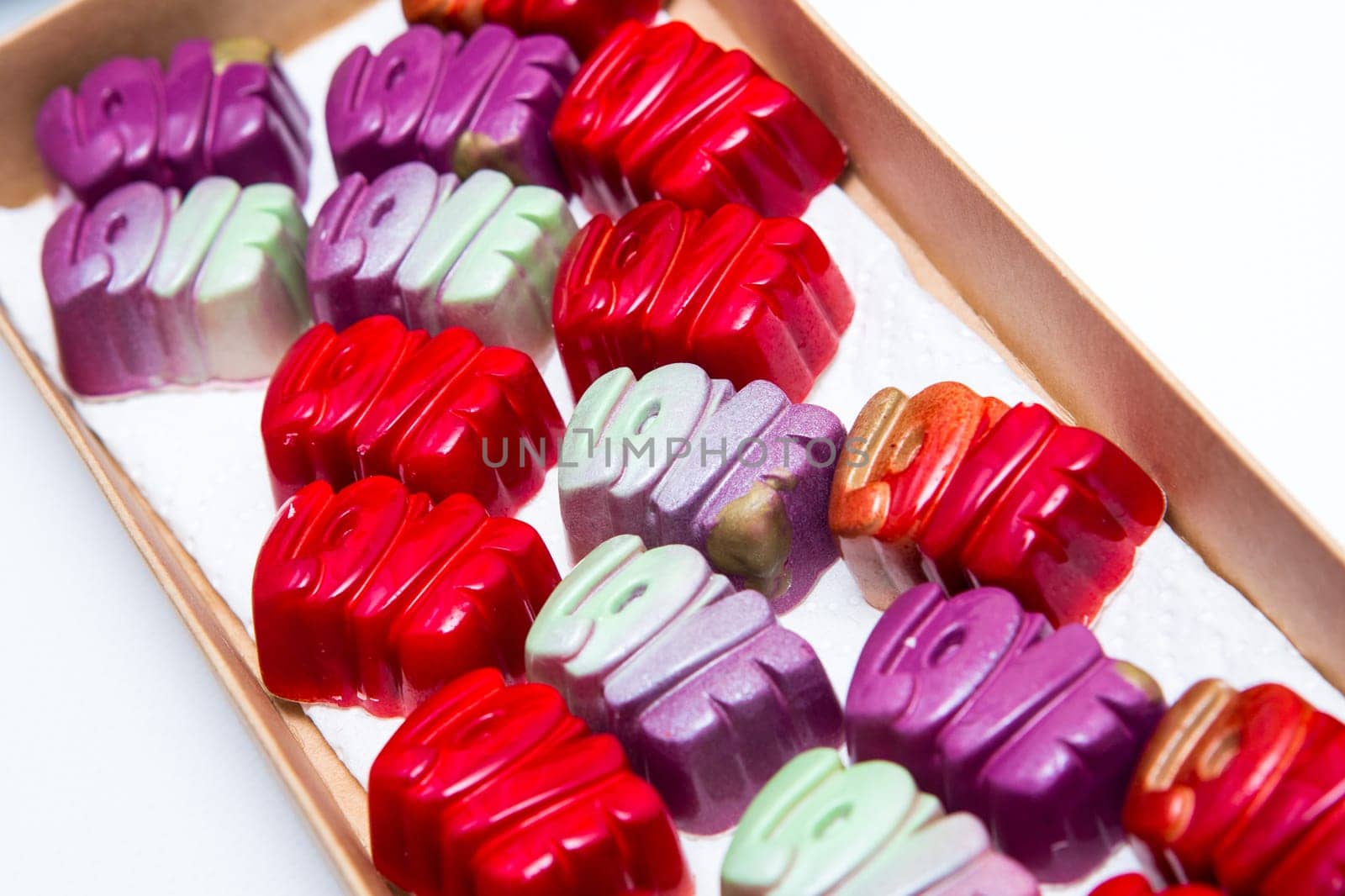 Delicious chocolate candies, close up, different colors.