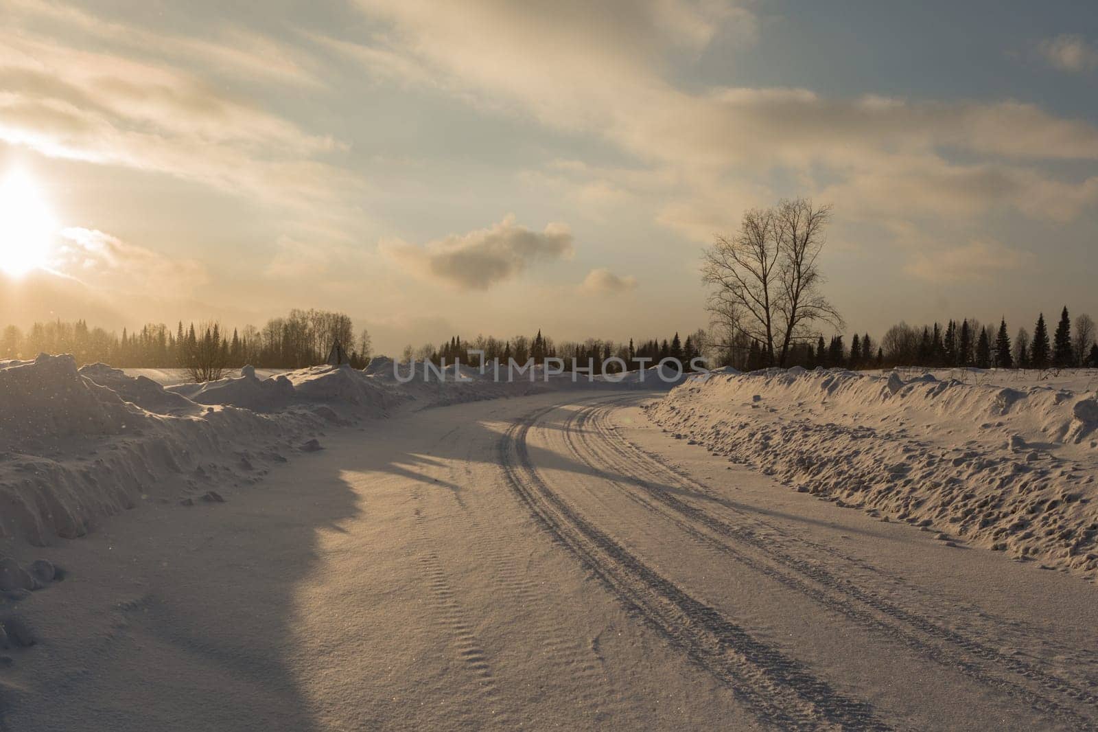 Empty snow covered road in winter landscape