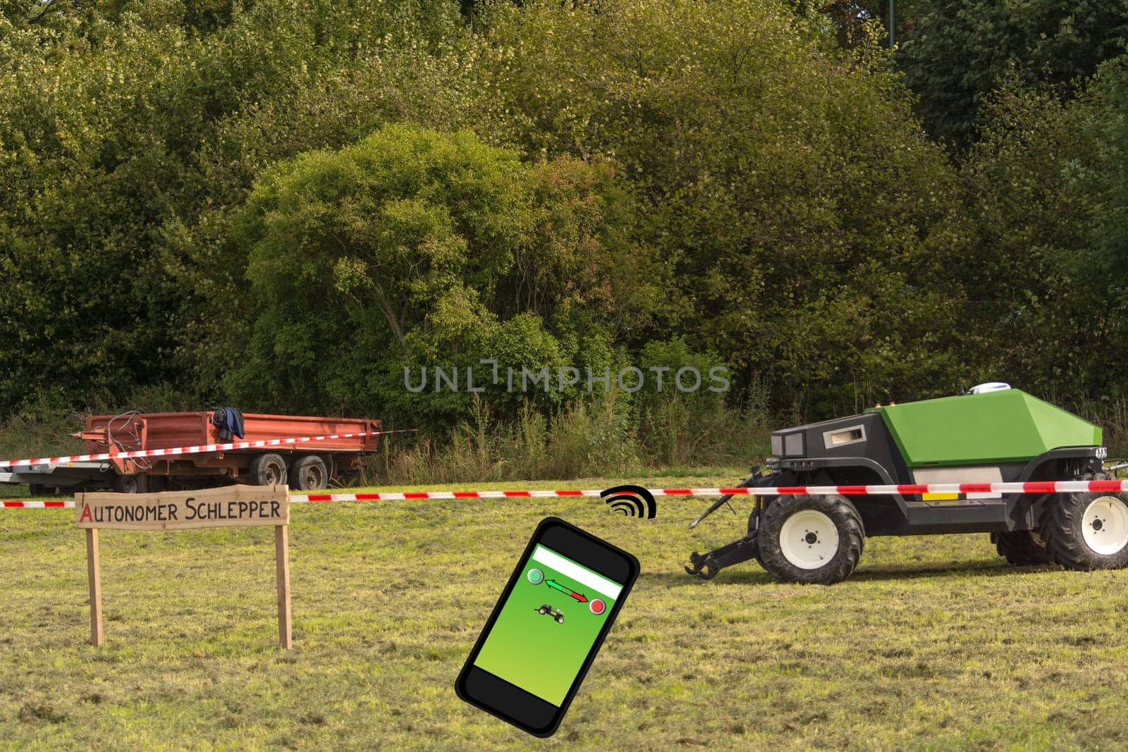Autonomous tractor in the field. Wooden sign with inscription in German autonomous tractor. Smart farming and digital transformation in agriculture.
