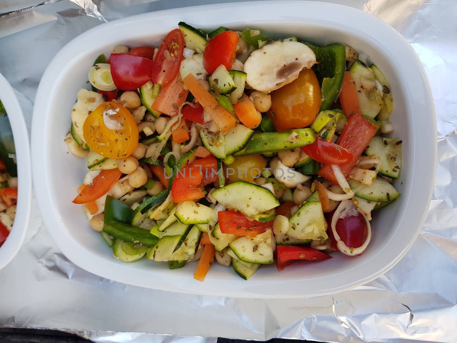 Grilled vegetables on a barbecue grill in a white bowl, top view