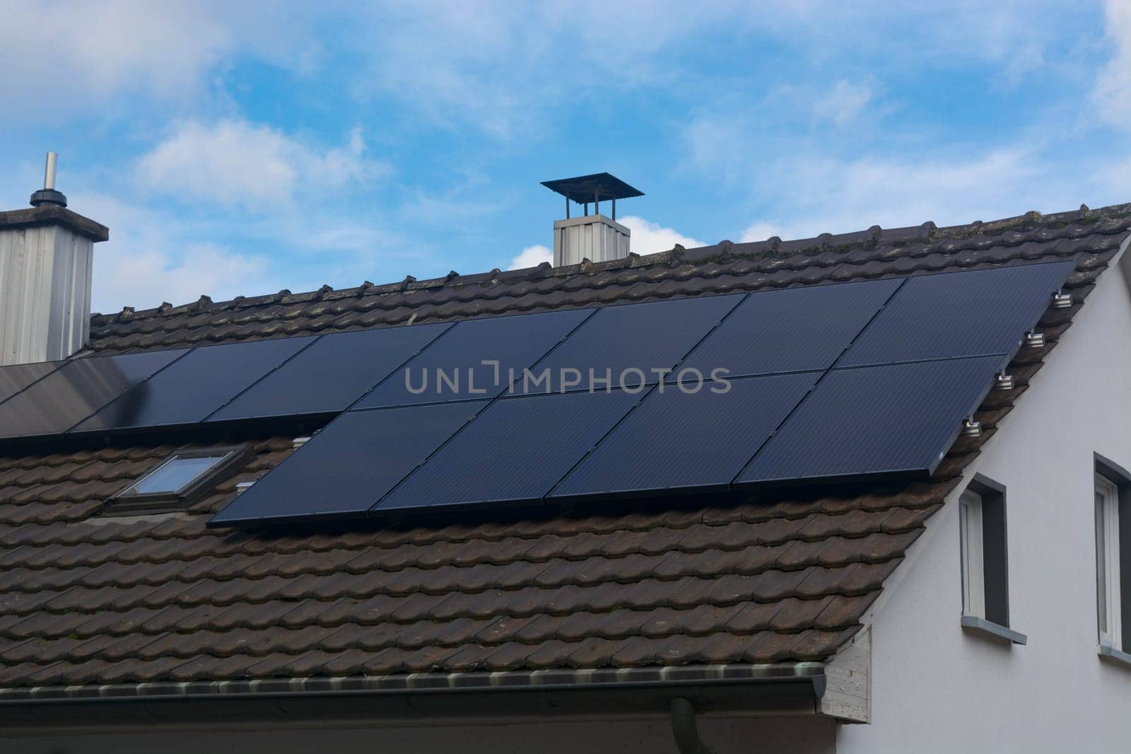 Modern house with a photovoltaic system, solar panels for electricity generation