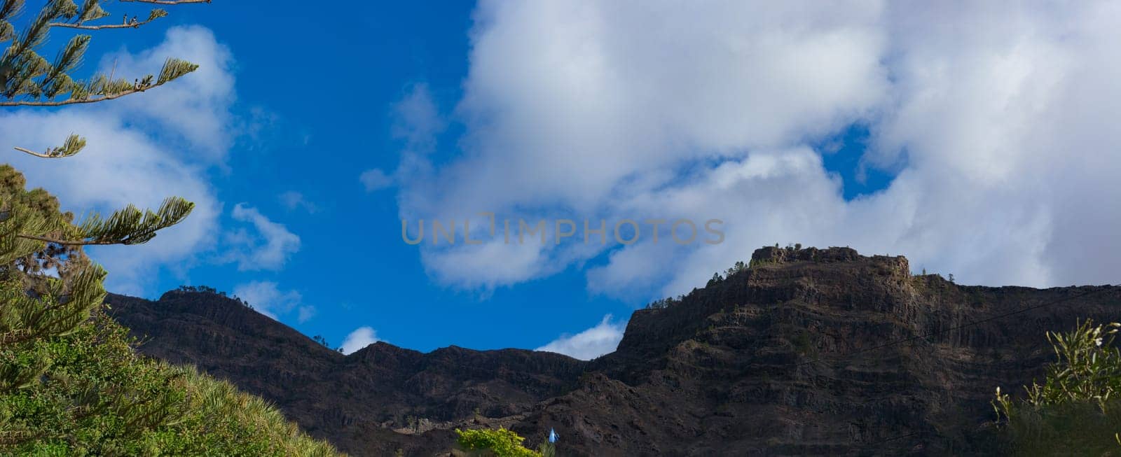 Mountains on the coast between Puerto de Mogan and Puerto Rico. Layers of volcanic rock.