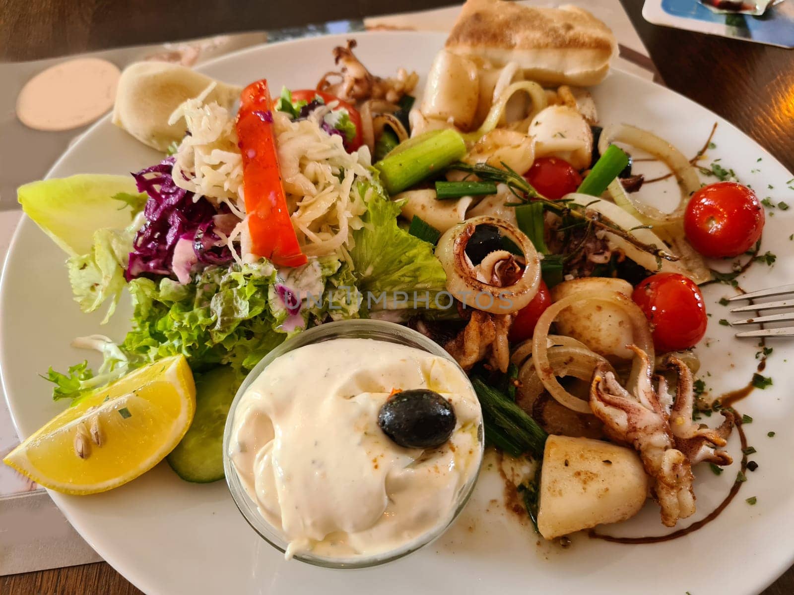 Grilled squid, street food. stuffed squid. salat.