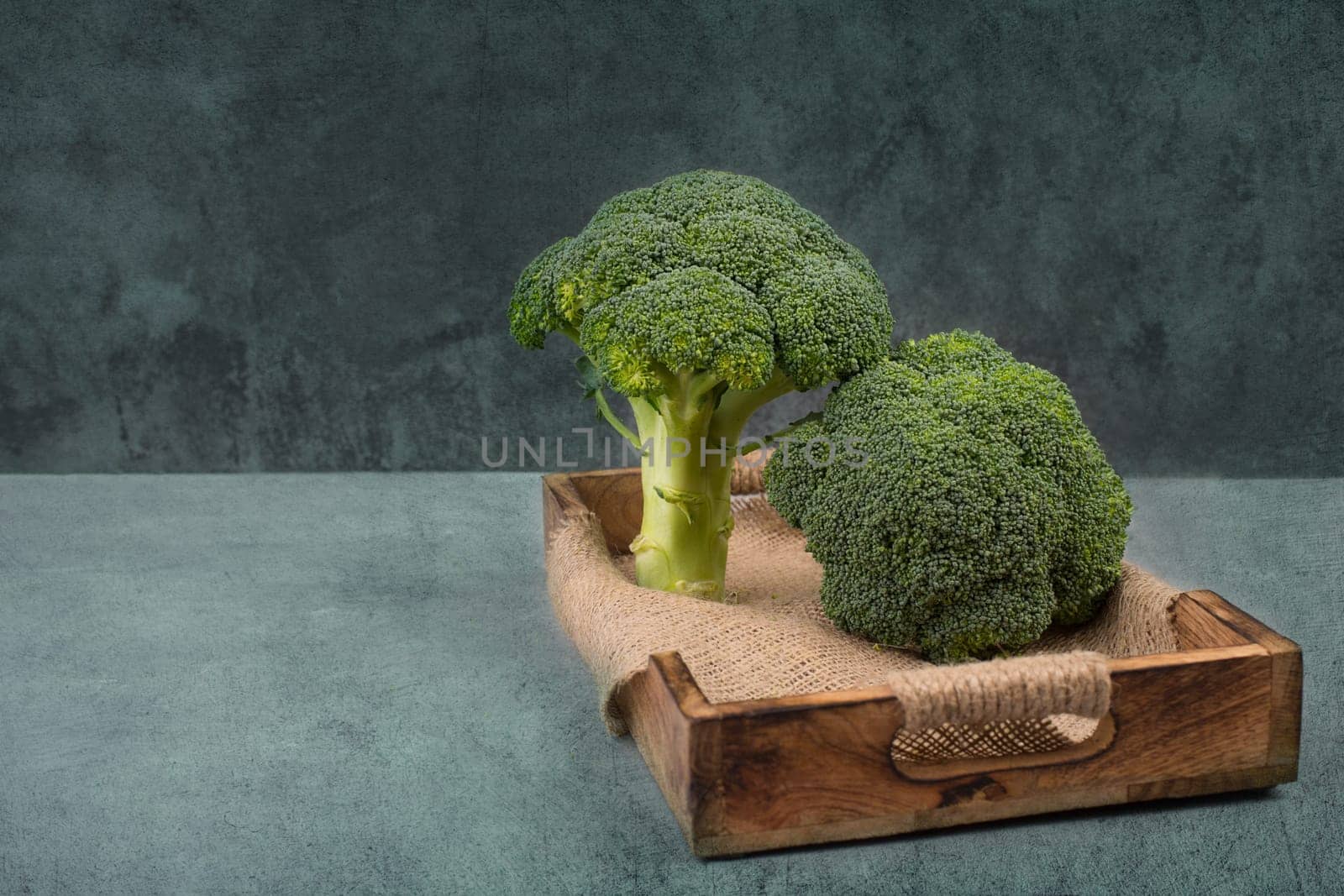 Fresh broccoli on a textured background, empty space for text