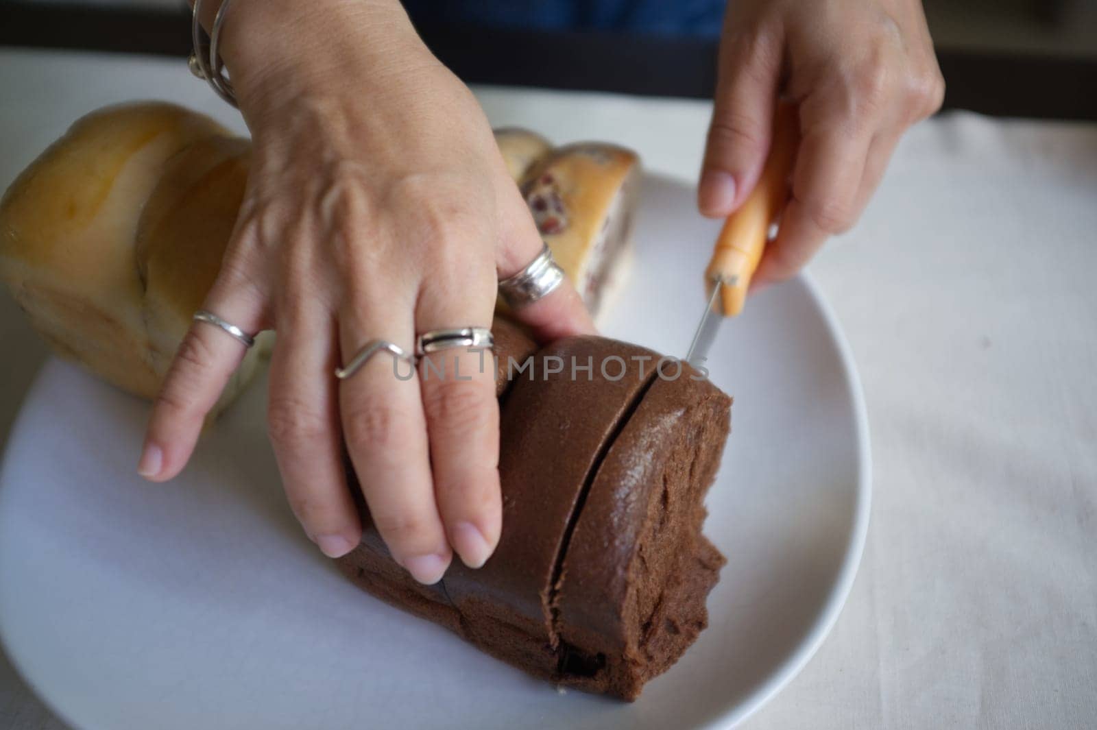 Woman holding gold knife for cut Fresh bread .