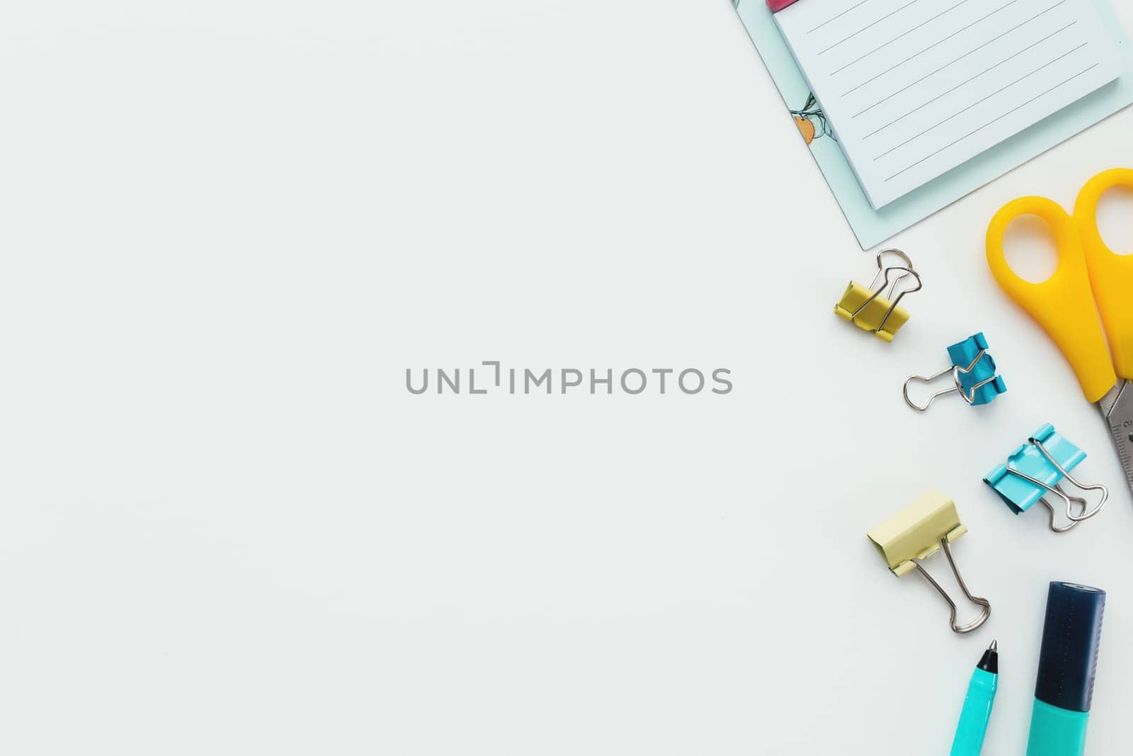 Paper clips, mechanical clock, marker and pencil, scissors on white background. Work and education concept. High quality photo