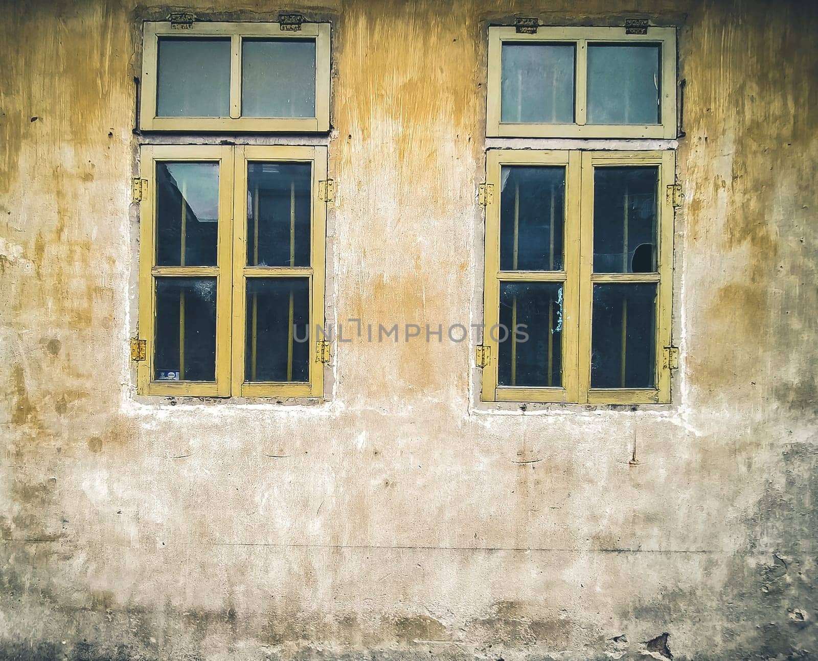 Architectural Details Vintage Window with Peeling Paint in orange.  Old vintage window of house old fashion design classic on rustic painted concrete wall background