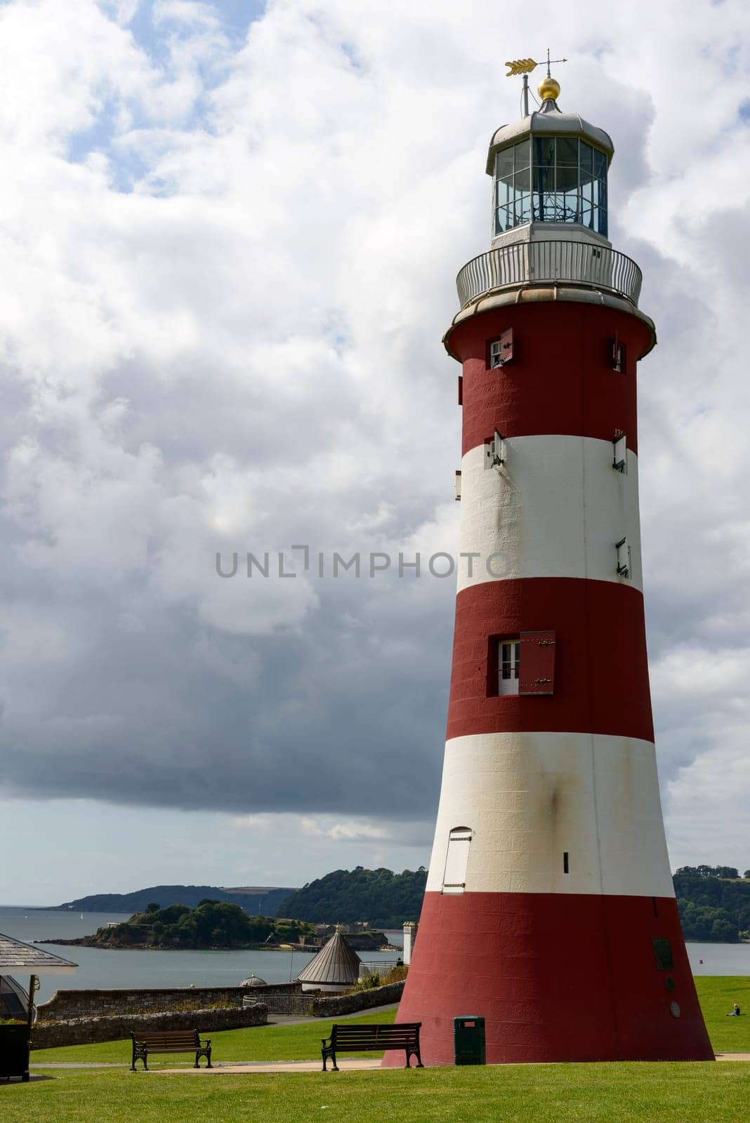 view of old light house at historic location in sea town of southern England.