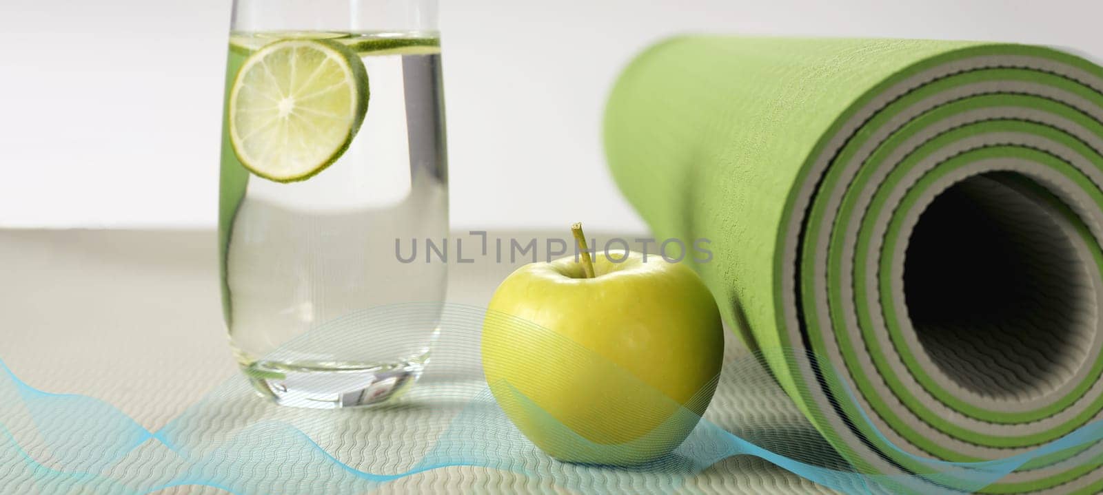 Yoga fitness, health life style. Yoga rolled mat, apple, glass of water with lemon, abstract wave. Place for text. Healthy lifestyle, fitness, sport concept