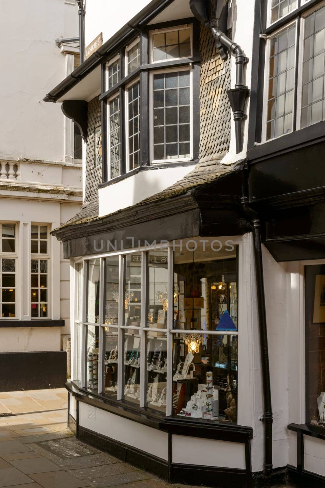 cityscape with detail  of an old shopping window of an historic  building in town center.