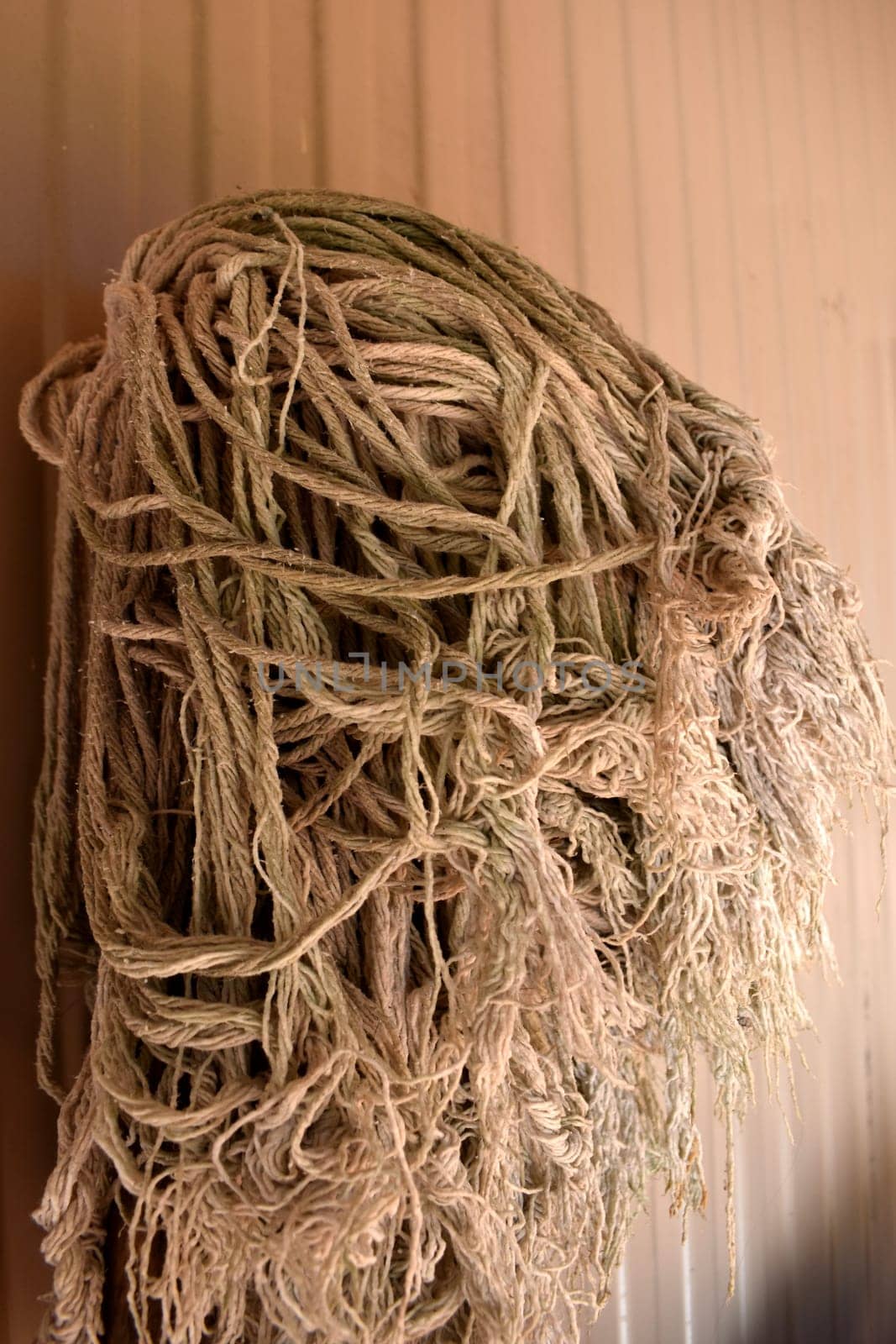 An old mop sitting against a wall