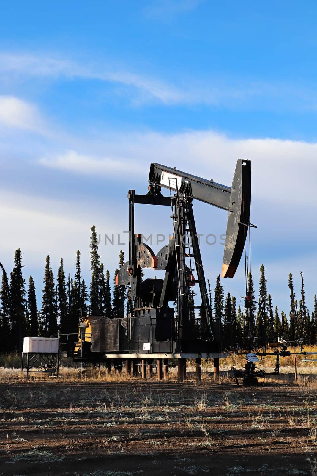 Stilled oil rigs with closed radigans signage.