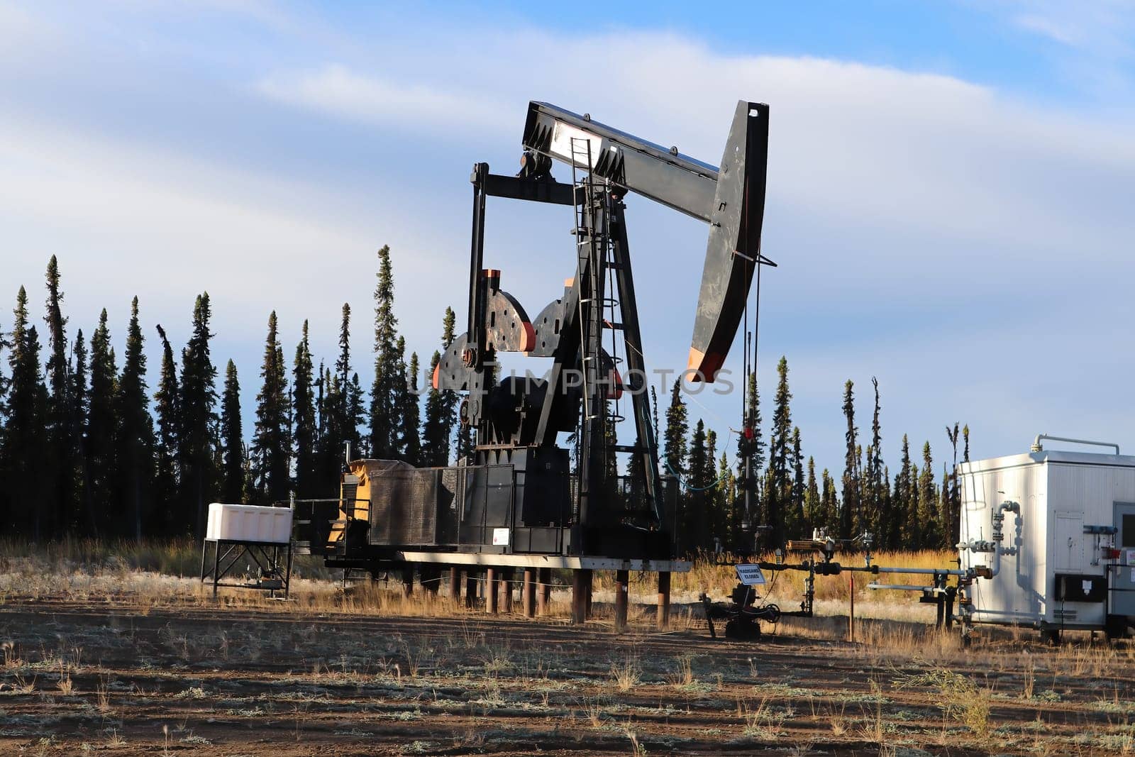 Stilled oil rigs with closed radigans signage.
