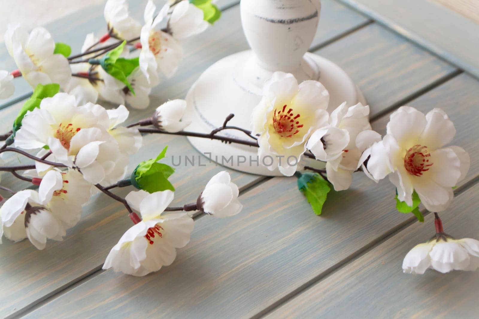 spring flowers decoration on blue painted wooden shabby planks.