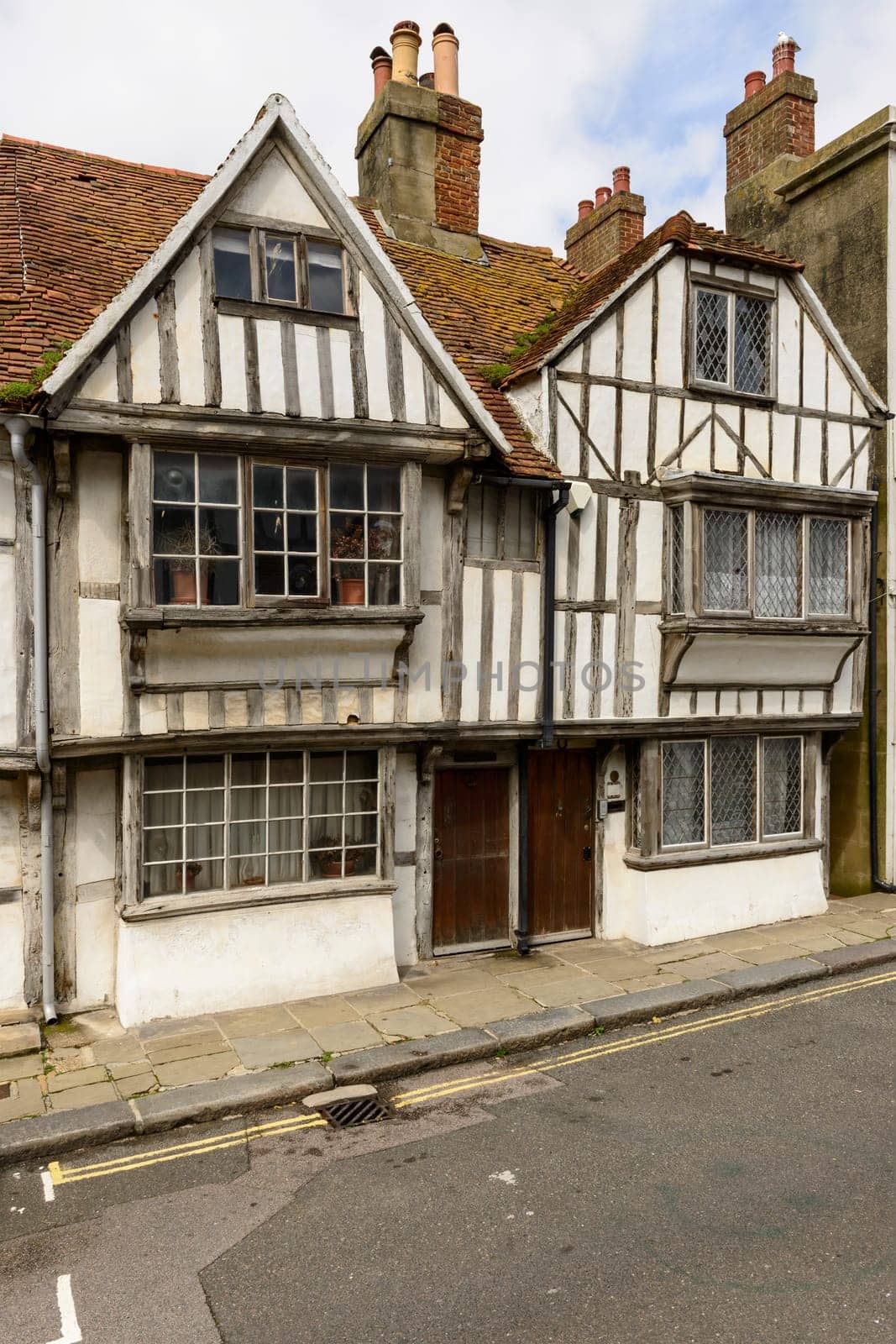 view of old wattle houses on a street in the historic village of Hastings, East Sussex .