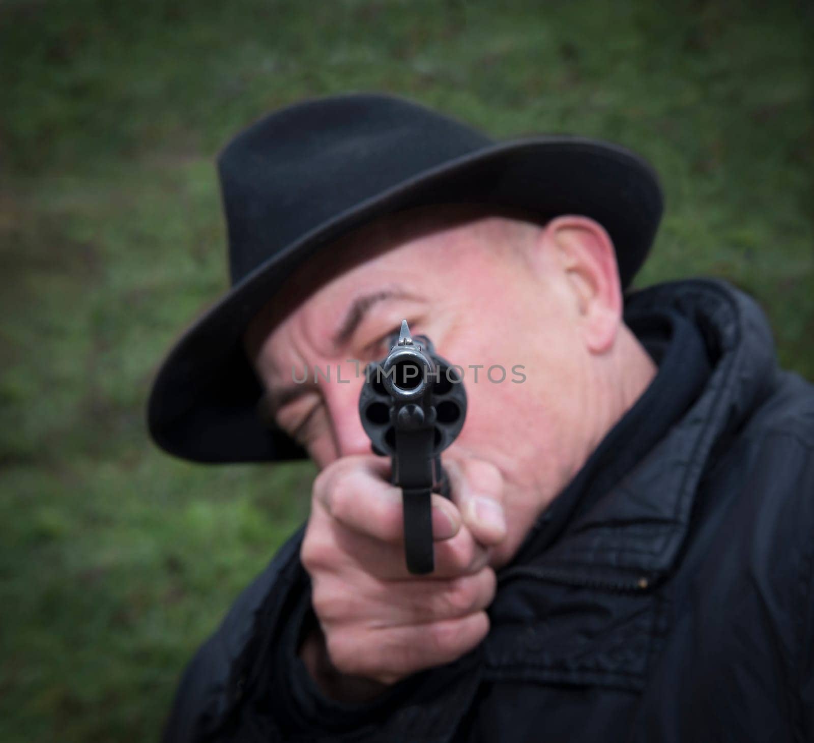 Man aiming a gun Nagan.