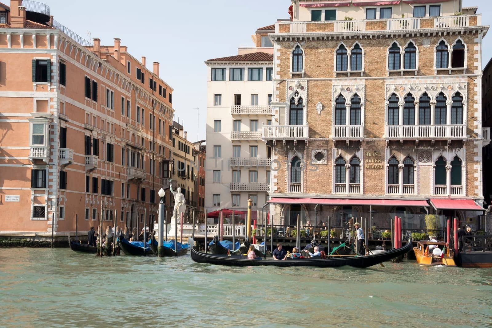 Venice, Italy- March 30, 2014: The gondolier floats on a gondola with tourists