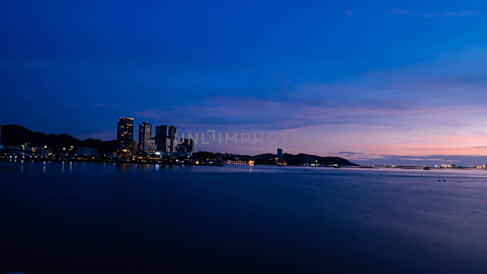 Panorama scenic of seascape with building on background and small mountain at dusk in Sriracha Chonburi Thailand