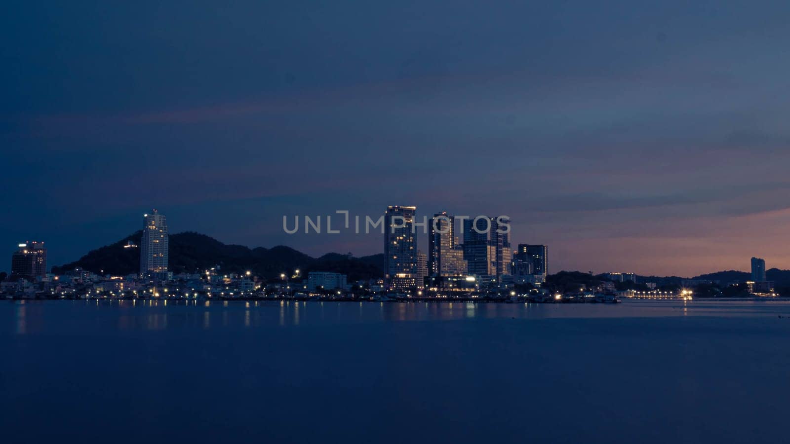 Panorama scenic of seascape with building on background and small mountain at dusk in Sriracha Chonburi Thailand