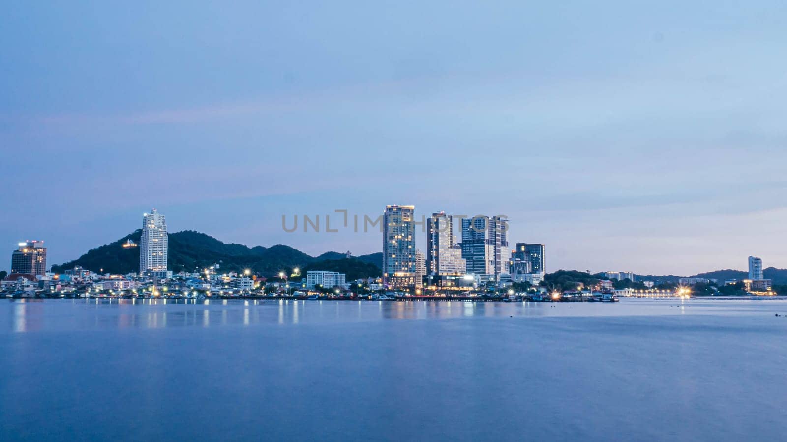 Panorama scenic of seascape with building on background and small mountain at dusk in Sriracha Chonburi Thailand