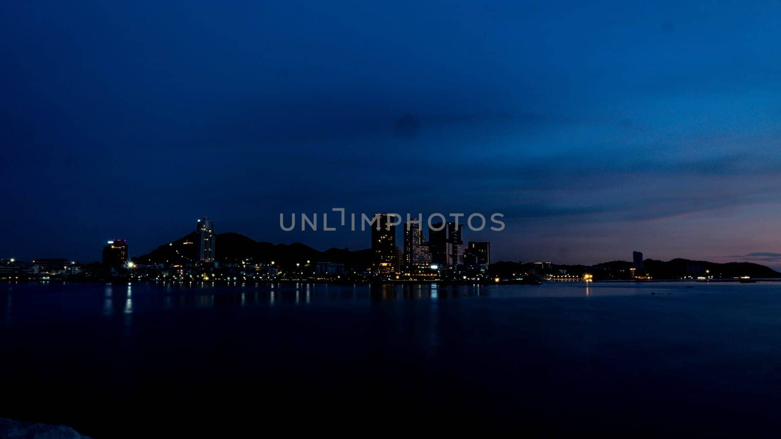 Panorama scenic of seascape with building on background and small mountain at dusk in Sriracha Chonburi Thailand