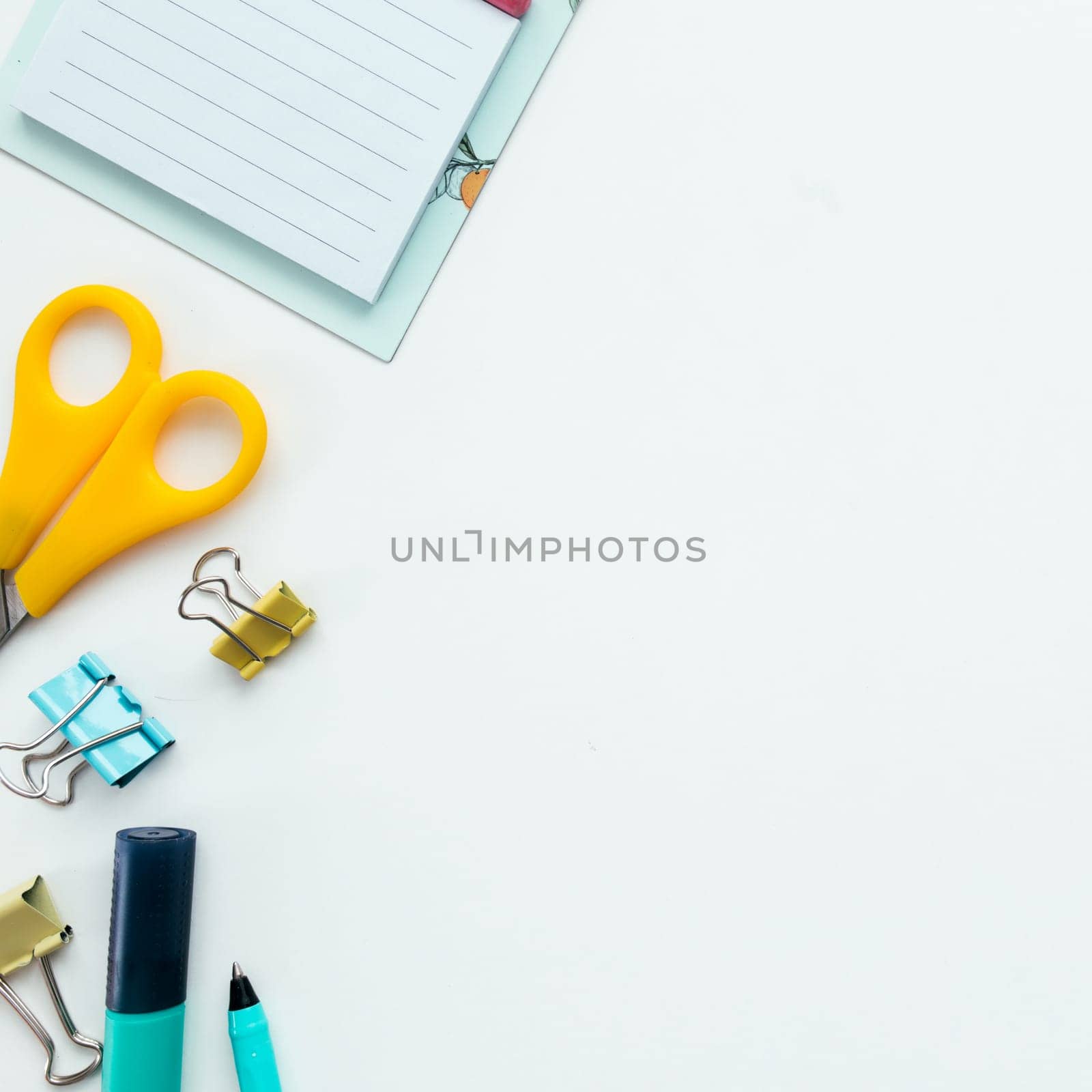 Paper clips, mechanical clock, marker and pencil, scissors on white background. Work and education concept. High quality photo
