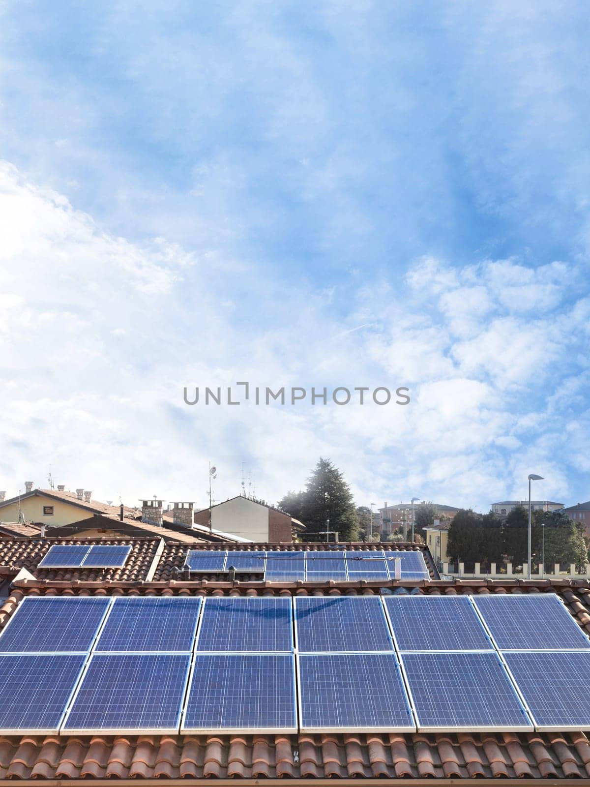 Solar panel on a red roof. Renewable energy source. Present technology. Vertical copy space on sky background.