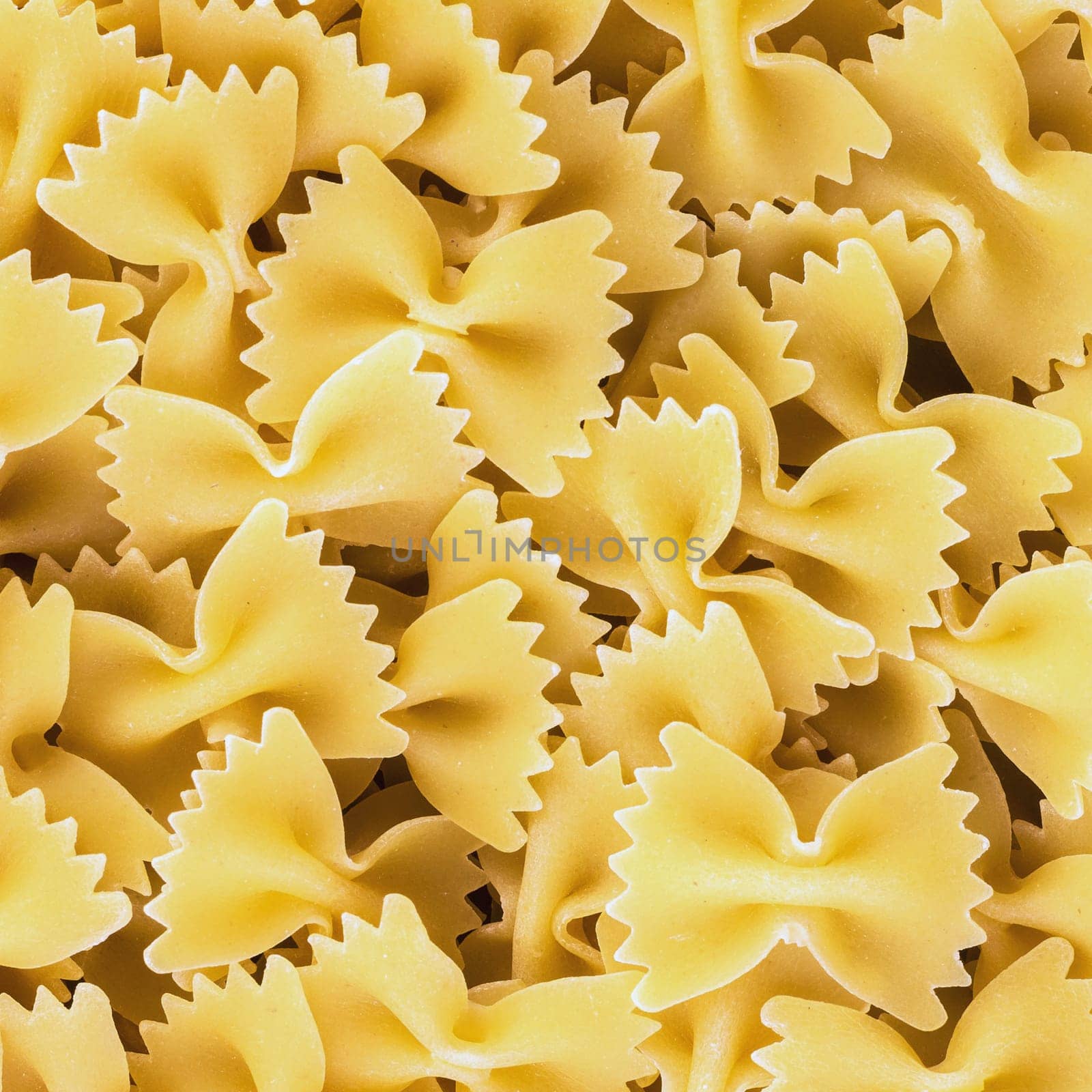 Traditional italian farfalle pasta. Famous variety of type and shape of Italian pasta. Dry pasta bows "farfalle""."