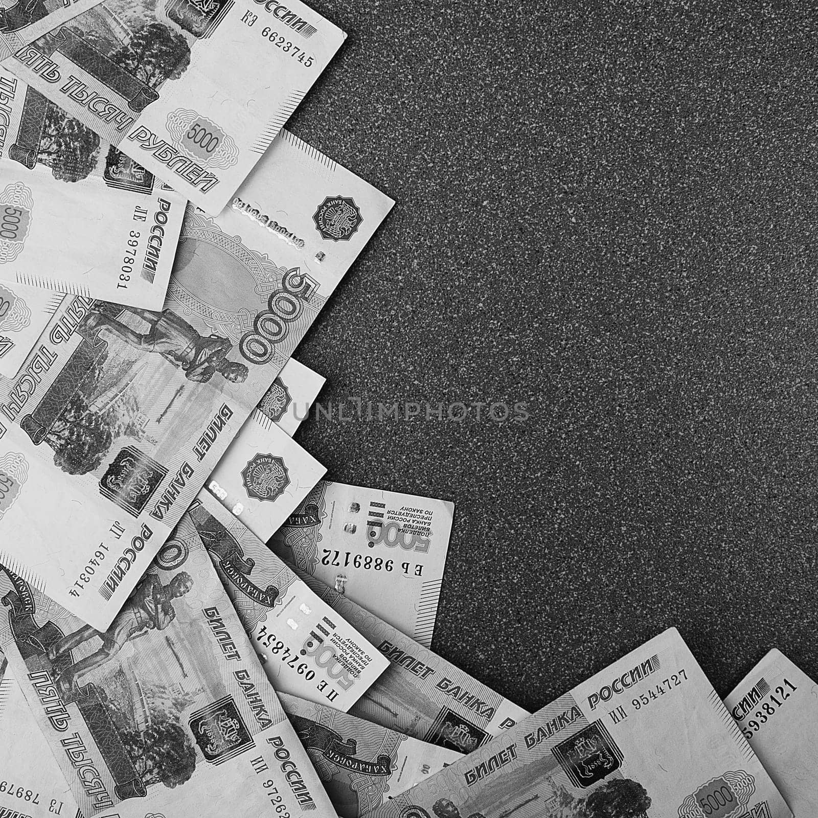 Russian cash banknotes of five thousand rubles, scattered on a gray background, there is a place for the inscription and text. Layout, layout.