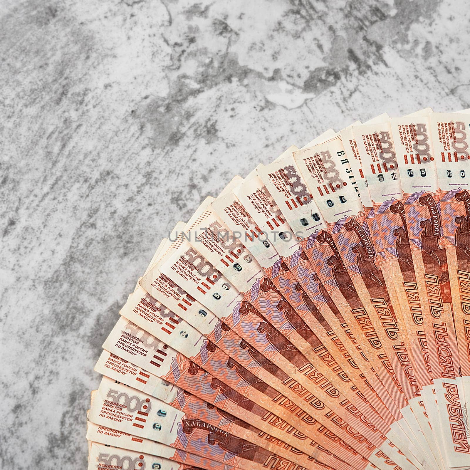 Russian money banknotes of five thousand rubles, background, banknotes are arranged in a fan on a gray background. Layout, mockup.