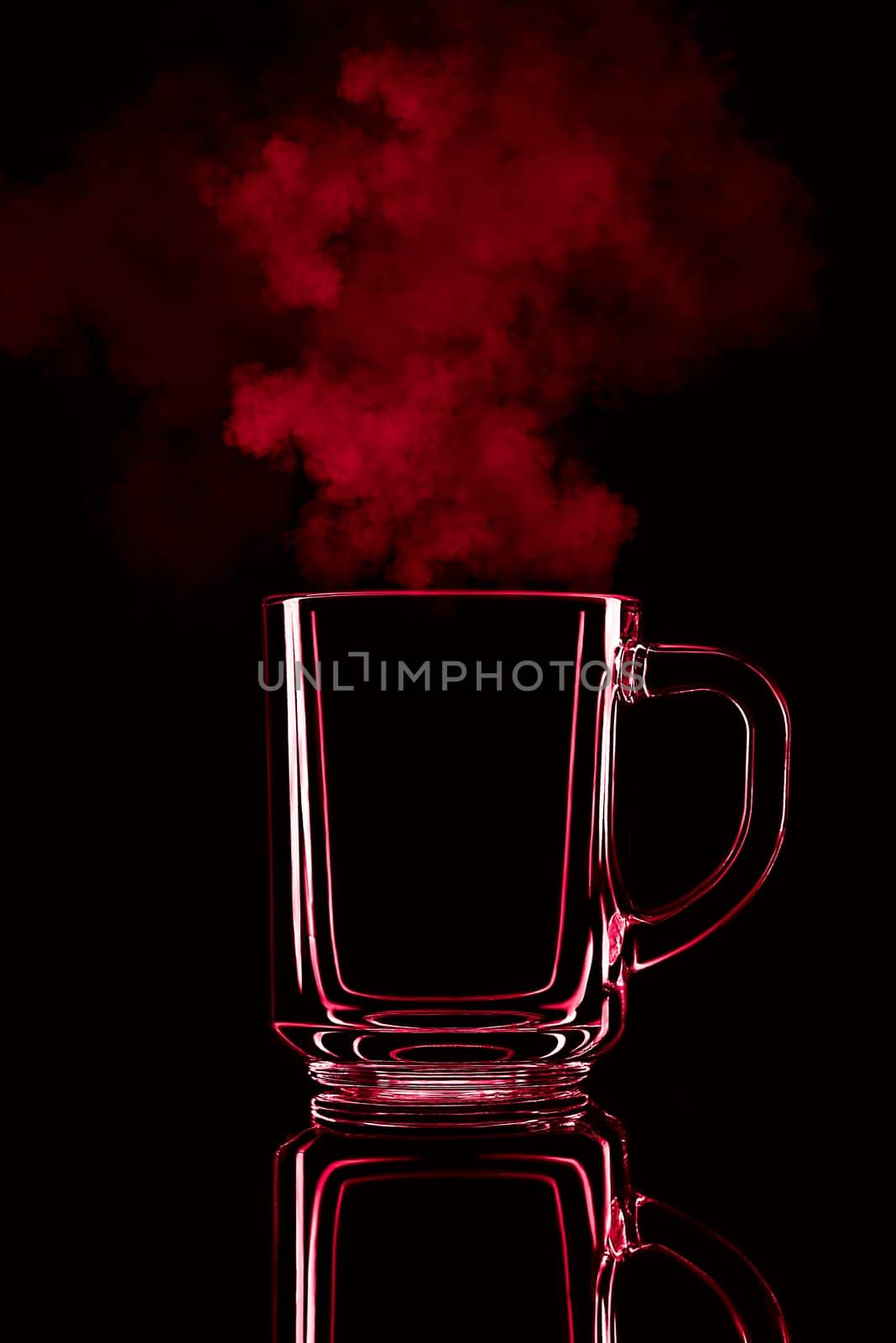 Just a glass on a black background with a reflection. Red color, with steam. Isolated.