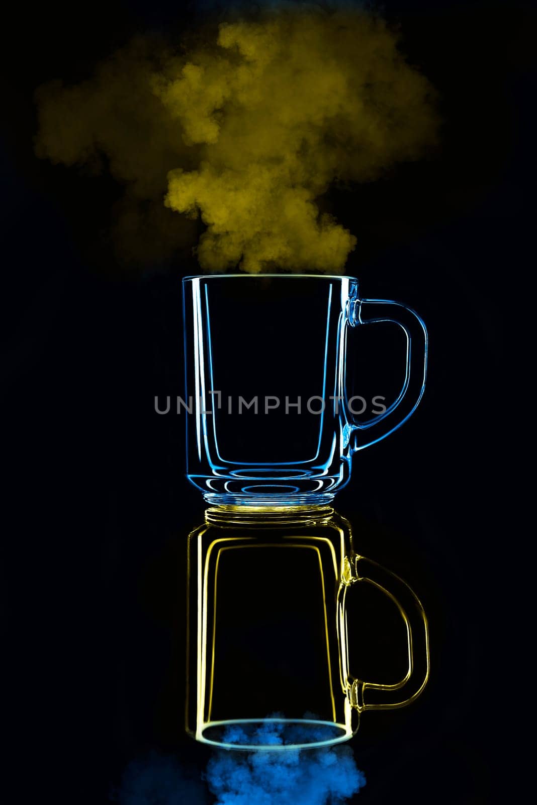 Just a glass on a black background with a reflection. Blue and yellow, with steam. Isolated.