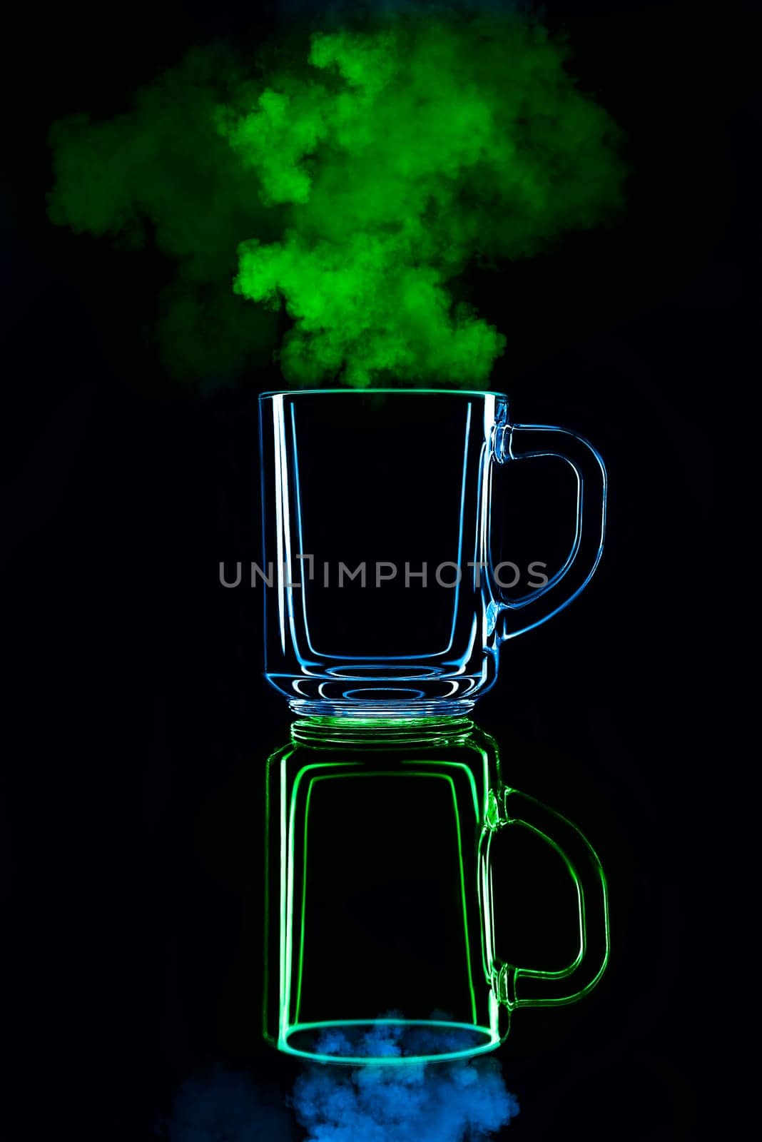 Just a glass on a black background with a reflection. Blue and green, with steam. Isolated.