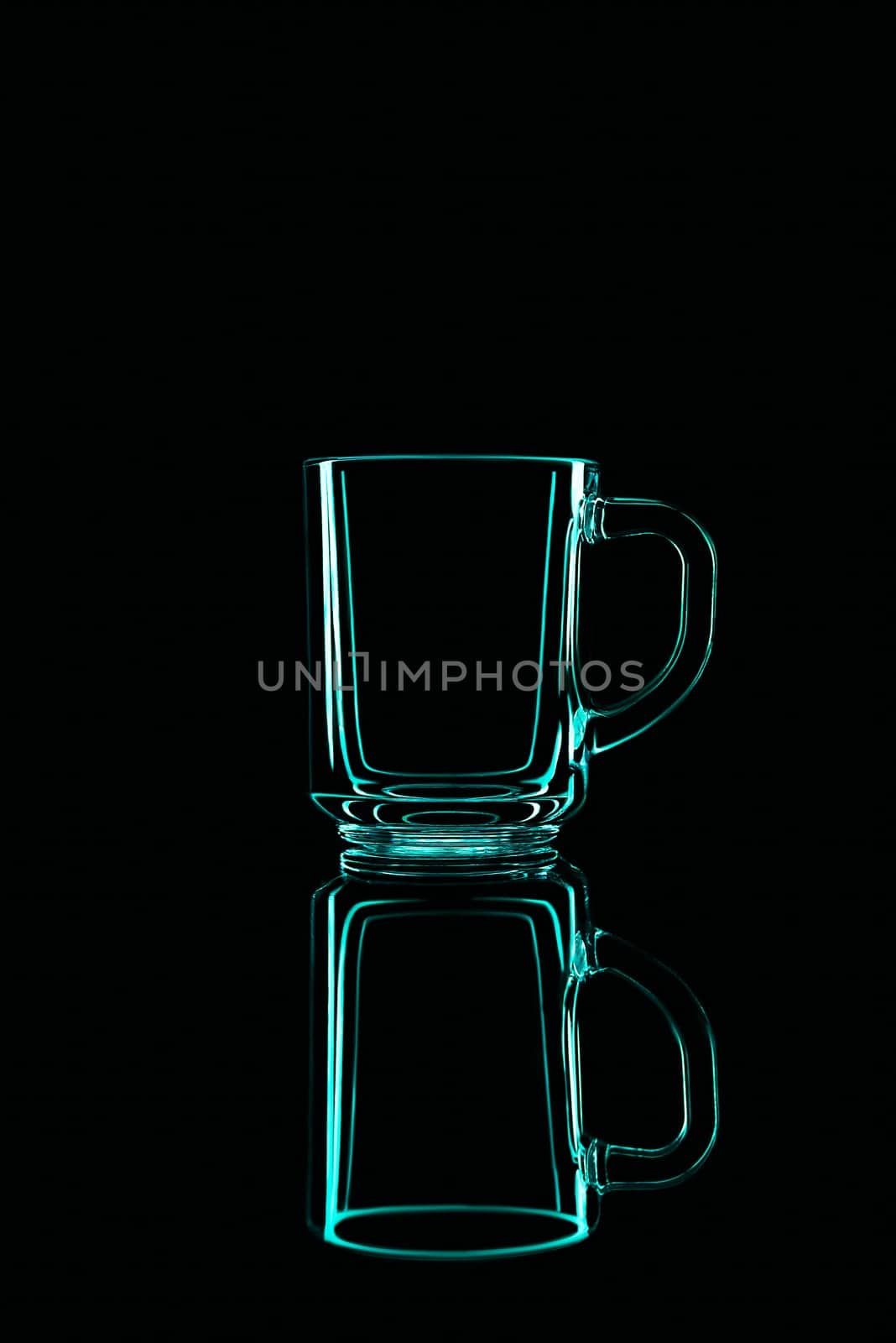 Just a glass on a black background with a reflection. Green colors. Isolated.