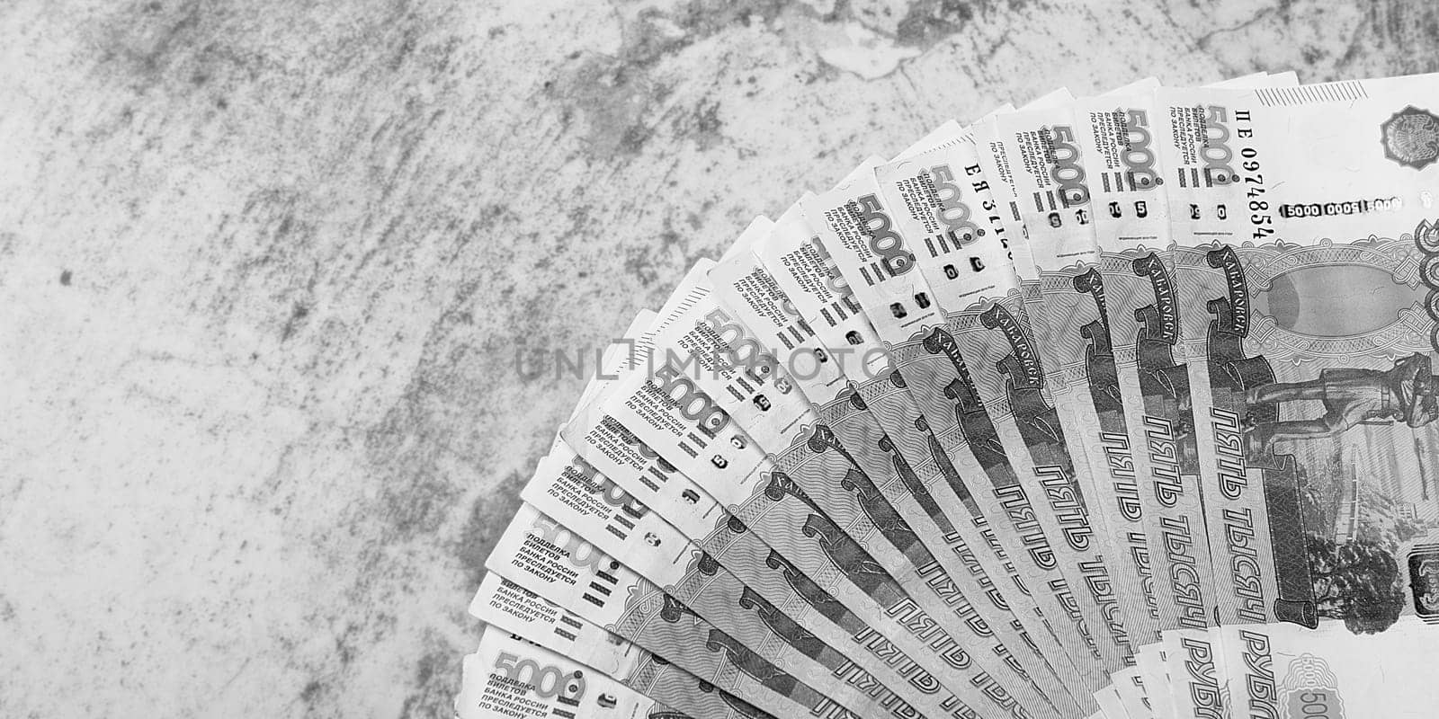 Russian money banknotes of five thousand rubles, background, banknotes are arranged in a fan on a gray background. Layout, mockup.