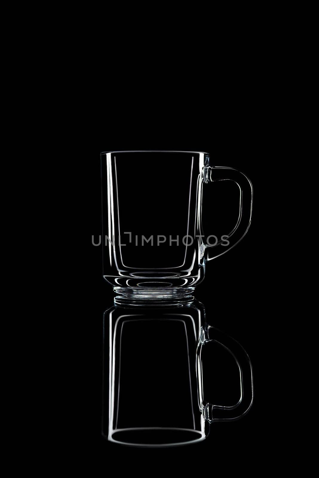 Just a glass on a black background with a reflection. Isolated.