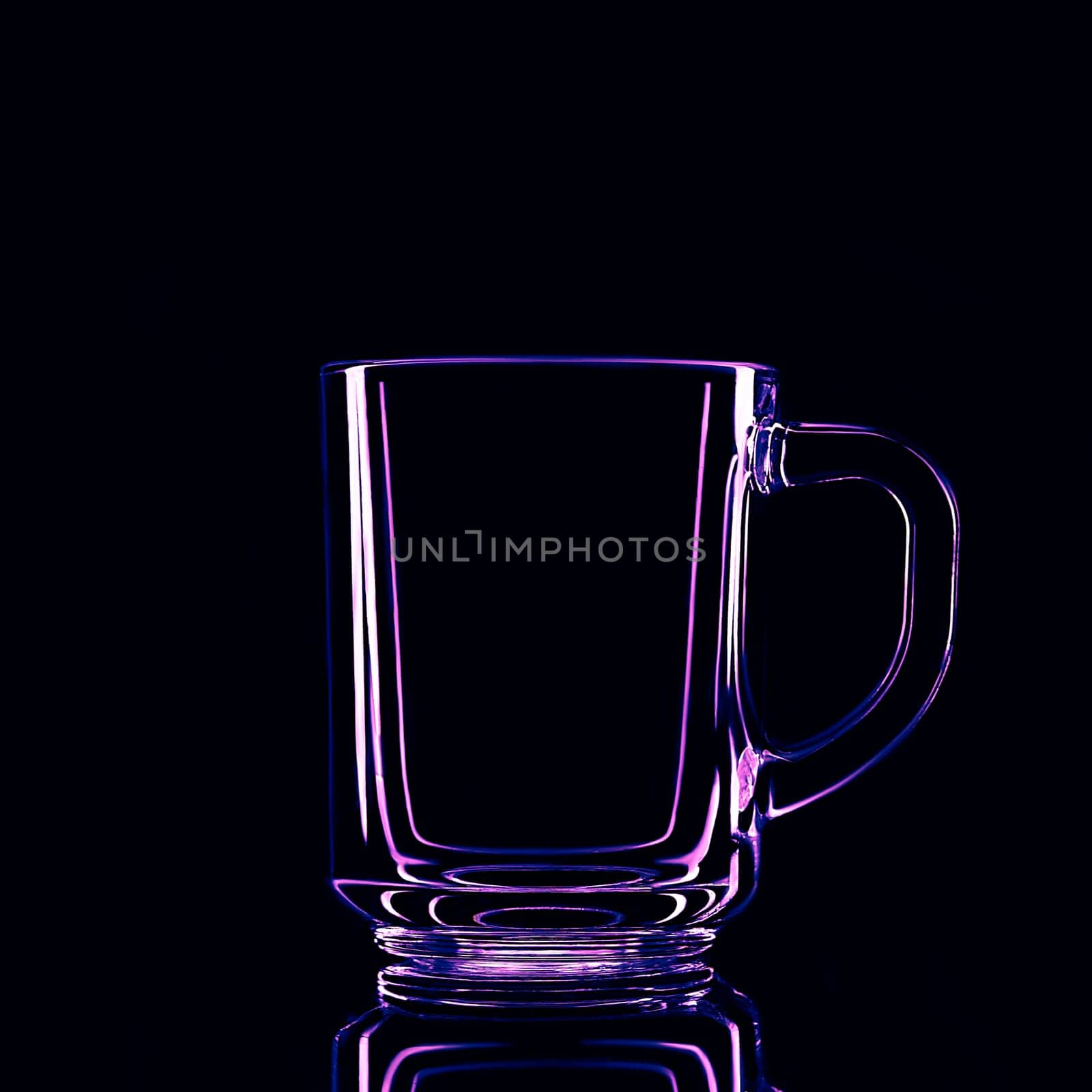 Just a glass on a black background with a reflection. Purple colors. Isolated.