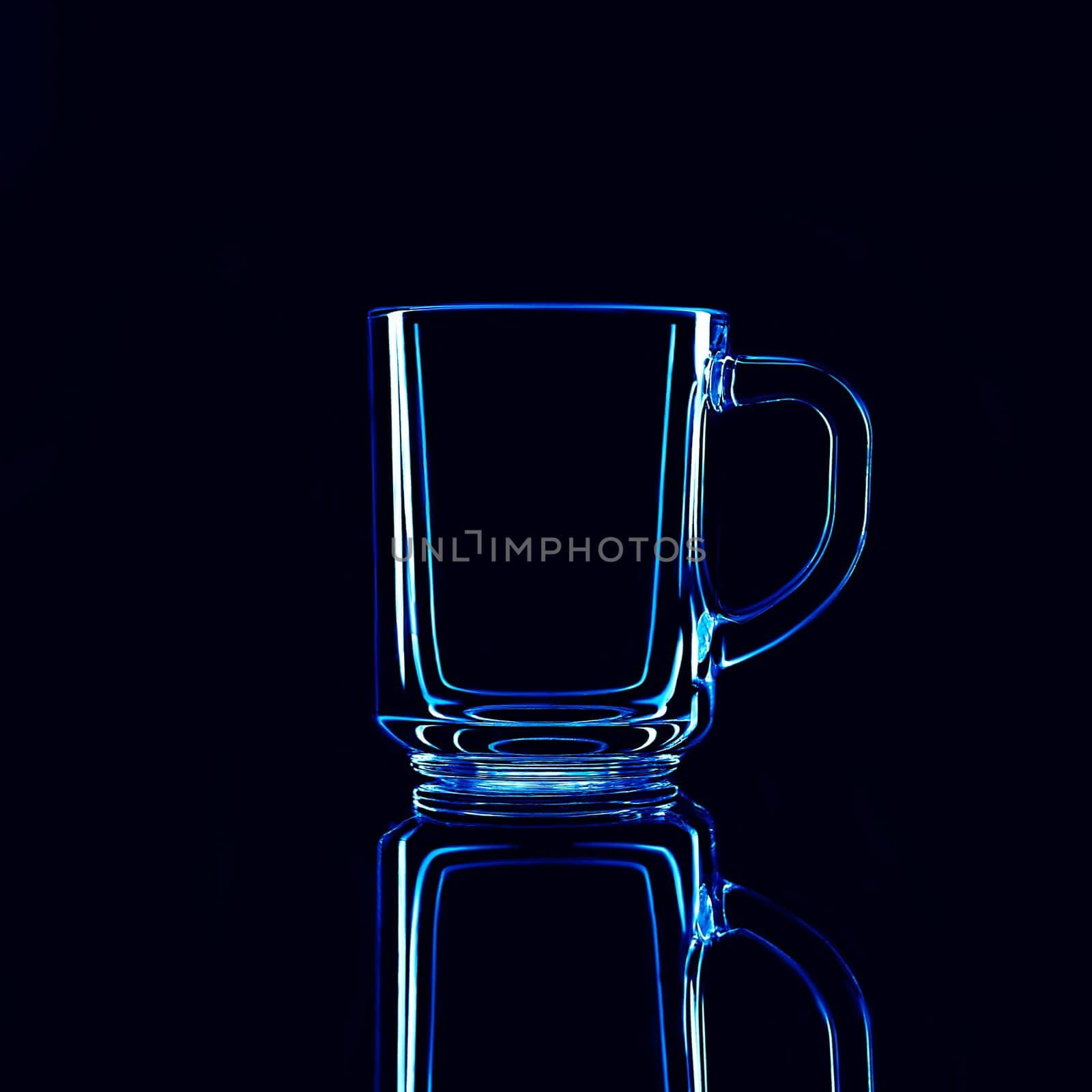 Just a glass on a black background with a reflection. Blue colors. Isolated.