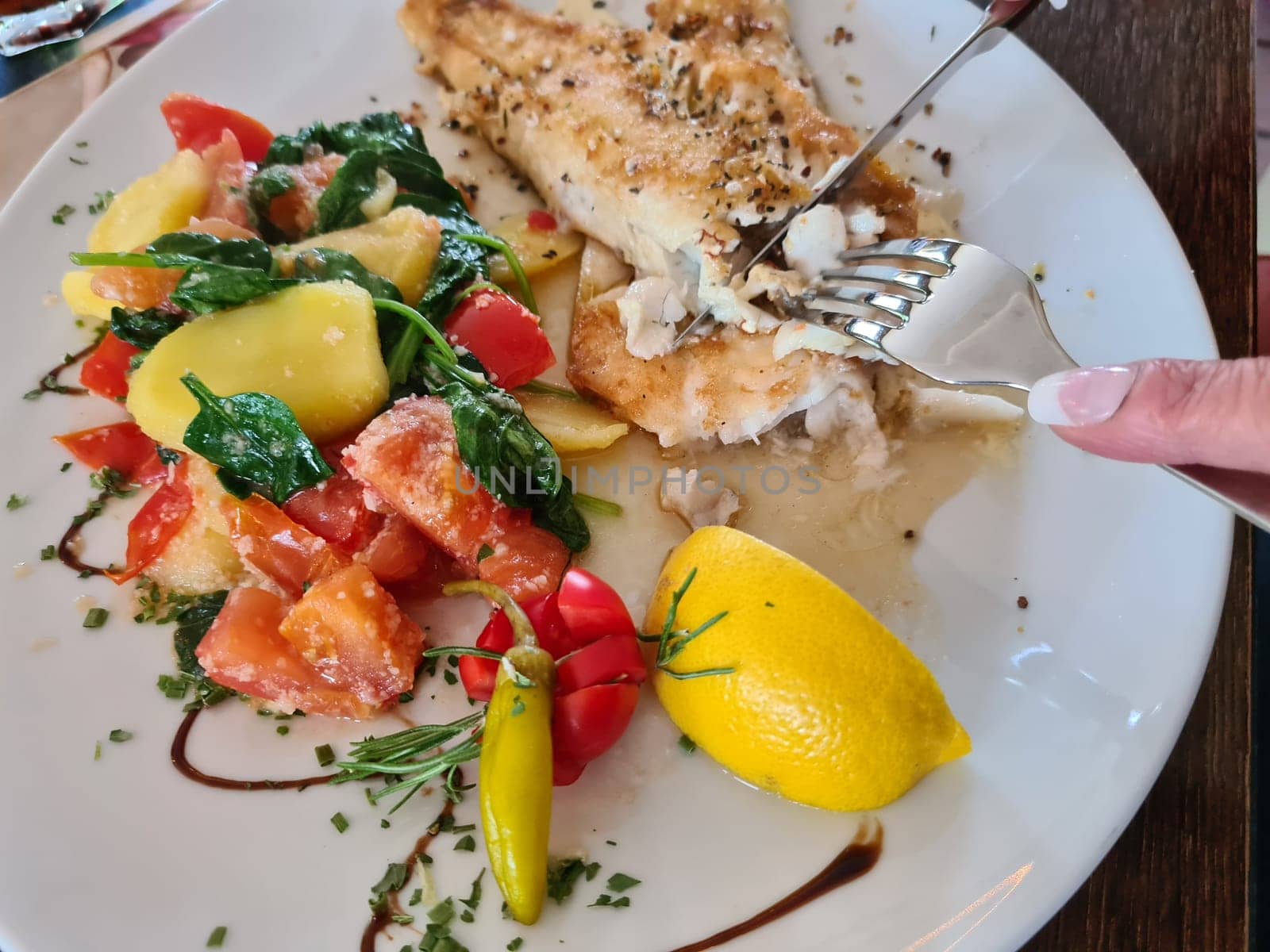 Pike perch fillet with asparagus, broccoli and carrots. Fried fish with stewed greens.