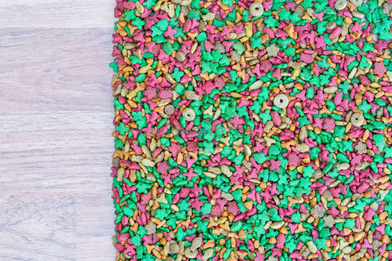 Top view dry cat food on wooden background with copy space