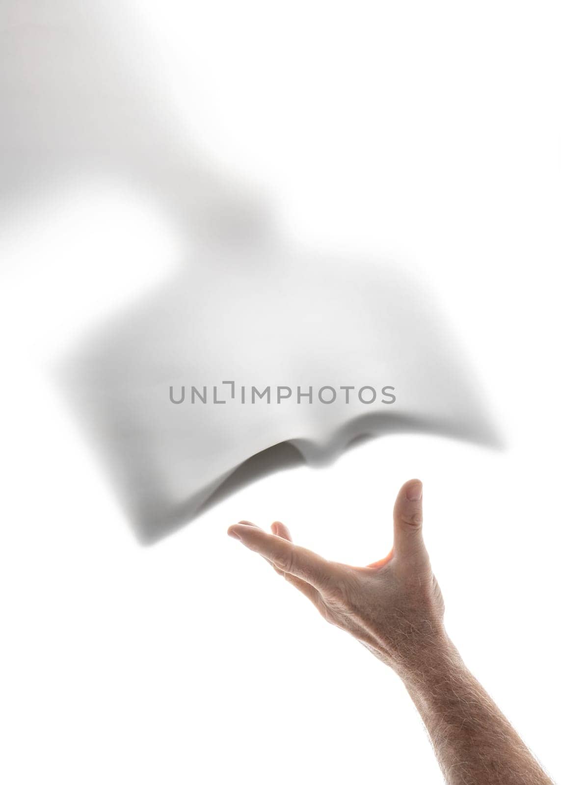 Human hand receiving the word of God brought by a heavenly messenger