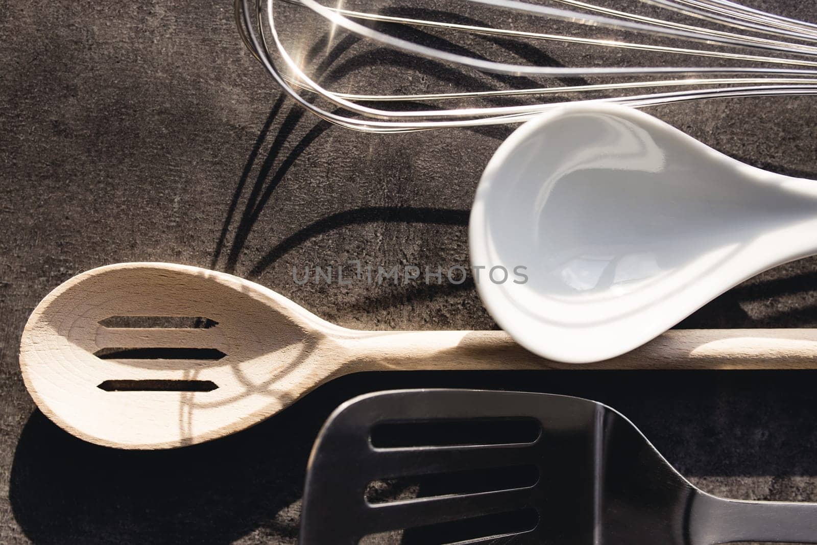 Top view of kitchen cutlery kit on gray background. High quality photo